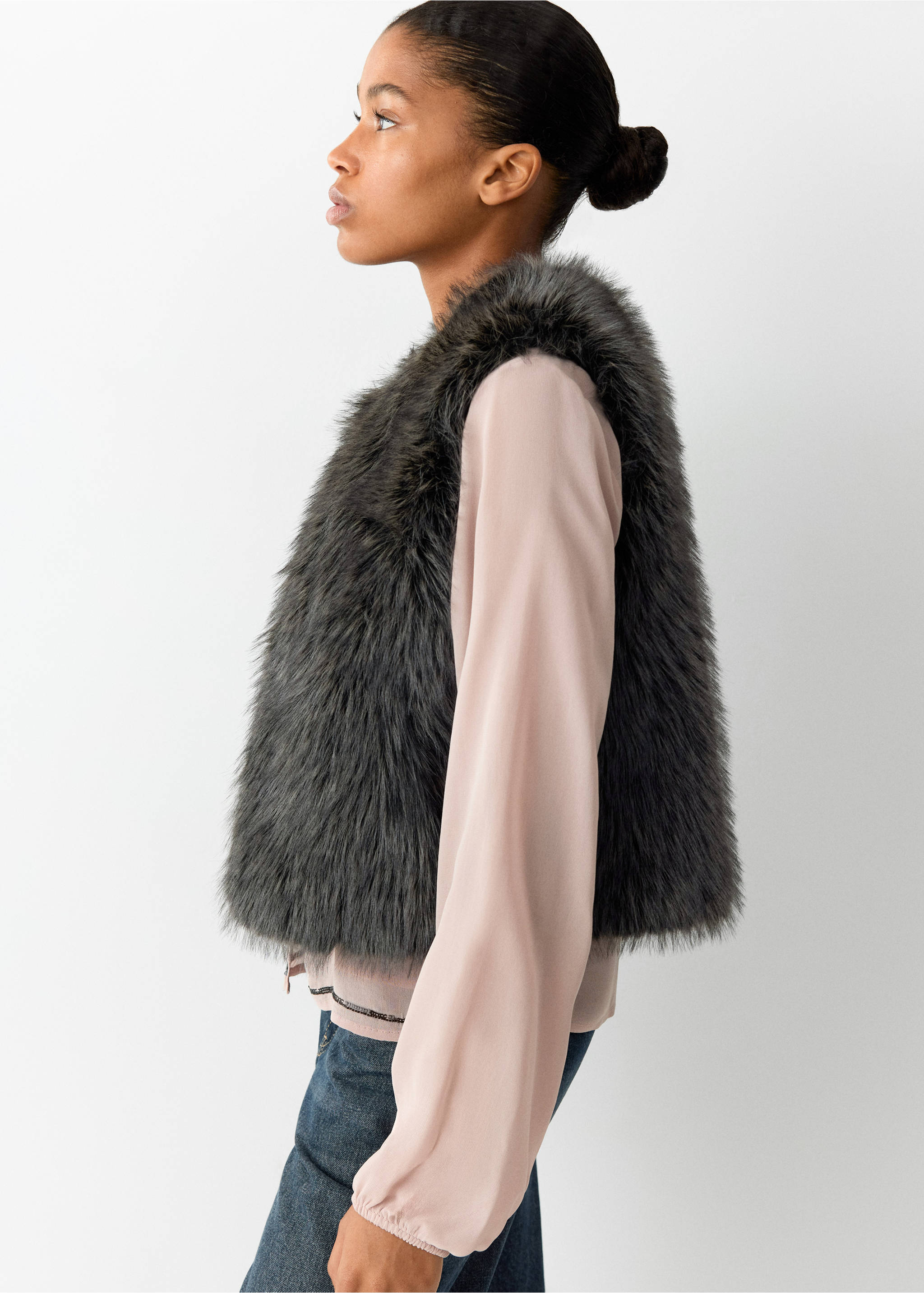 Dark grey faux-fur vest worn over a pink blouse., Black. Ref: 37098261-00.