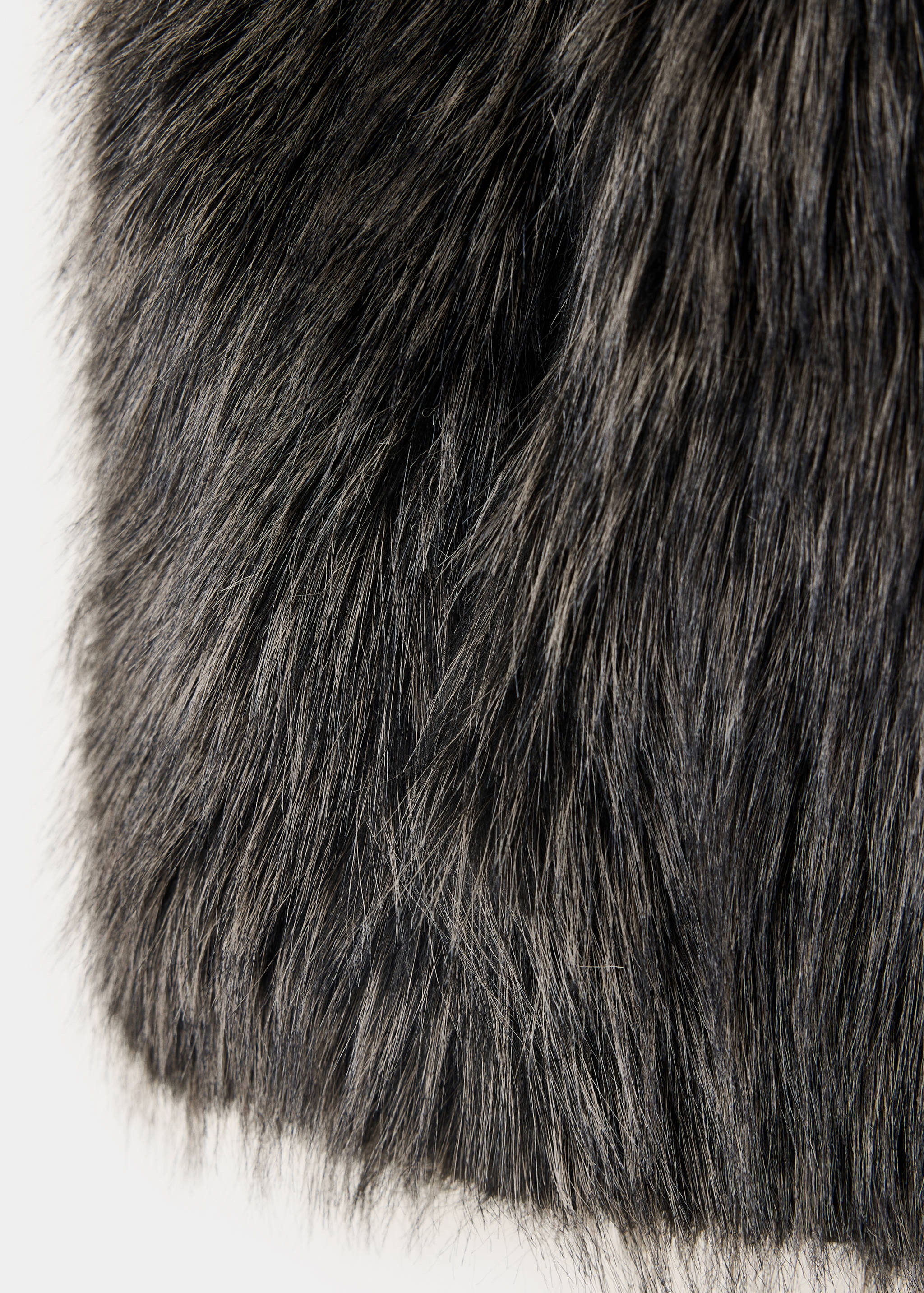 Close-up of dark grey faux-fur gilet texture.