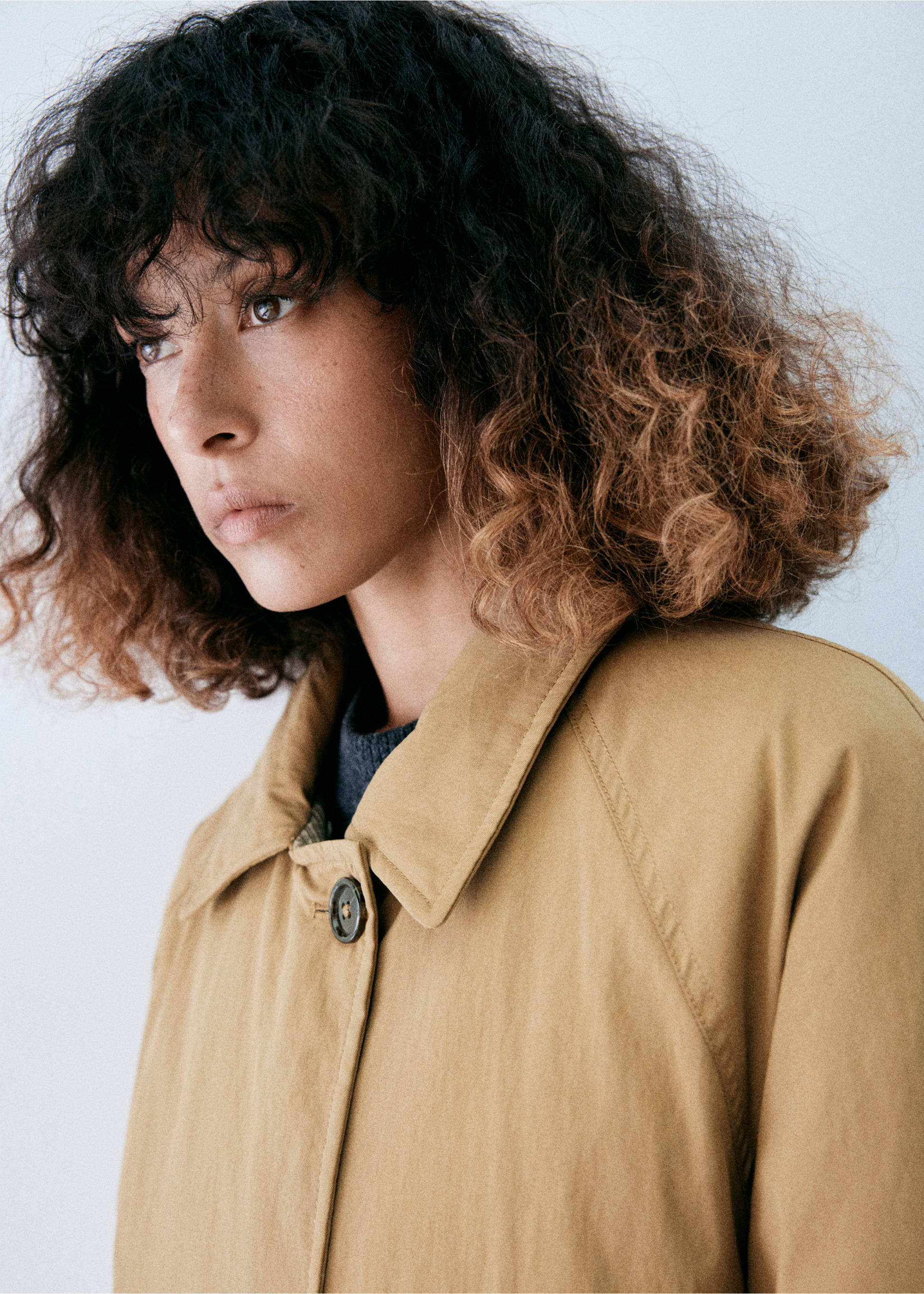 Close-up of a model wearing a tan parka with a pointed collar., Beige. Ref: 37098264-00.