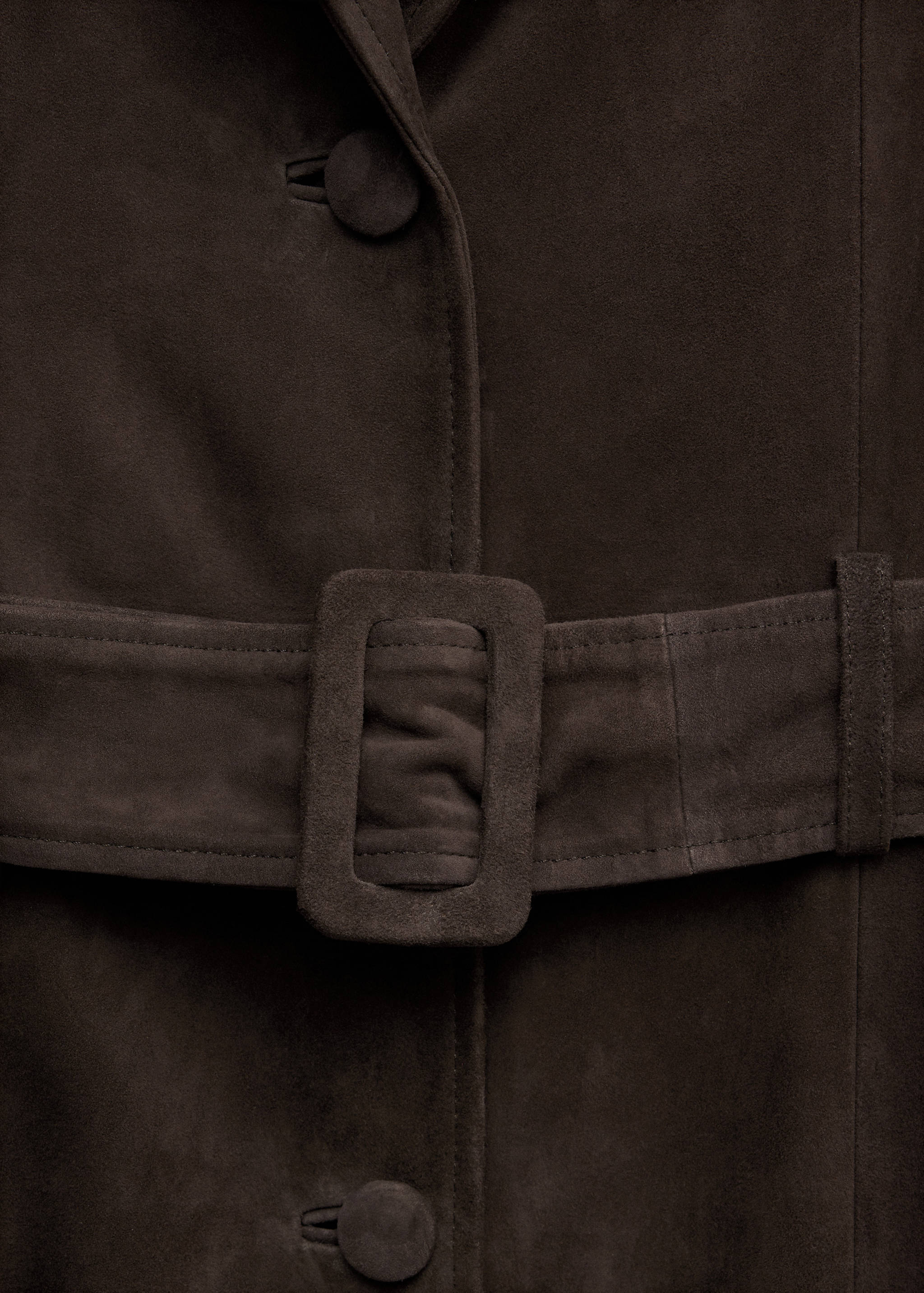 Close-up of a dark brown coat featuring a matching belt and fabric-covered buttons.