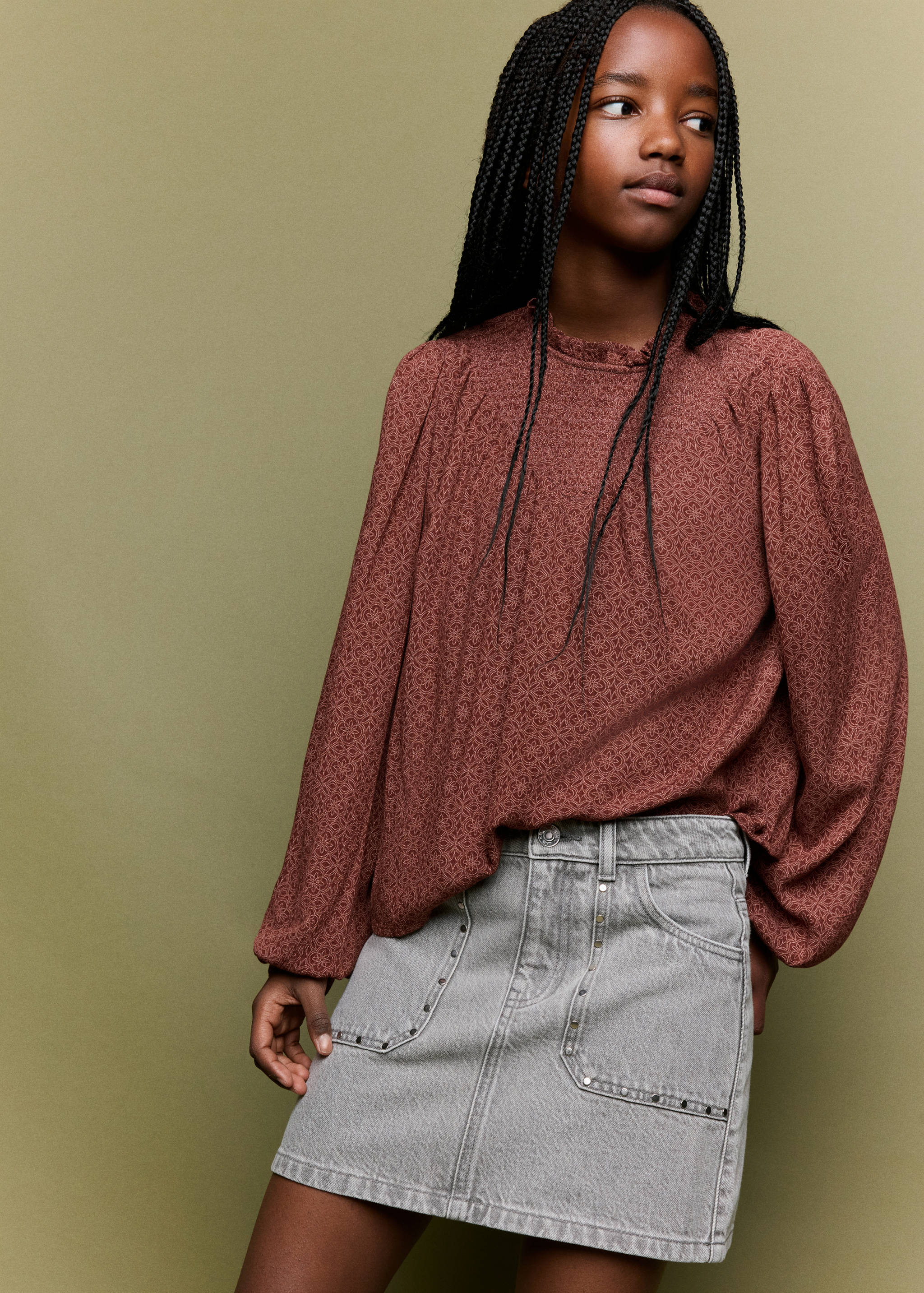 Printed brown blouse with long raglan sleeves and a ruffled high neckline
