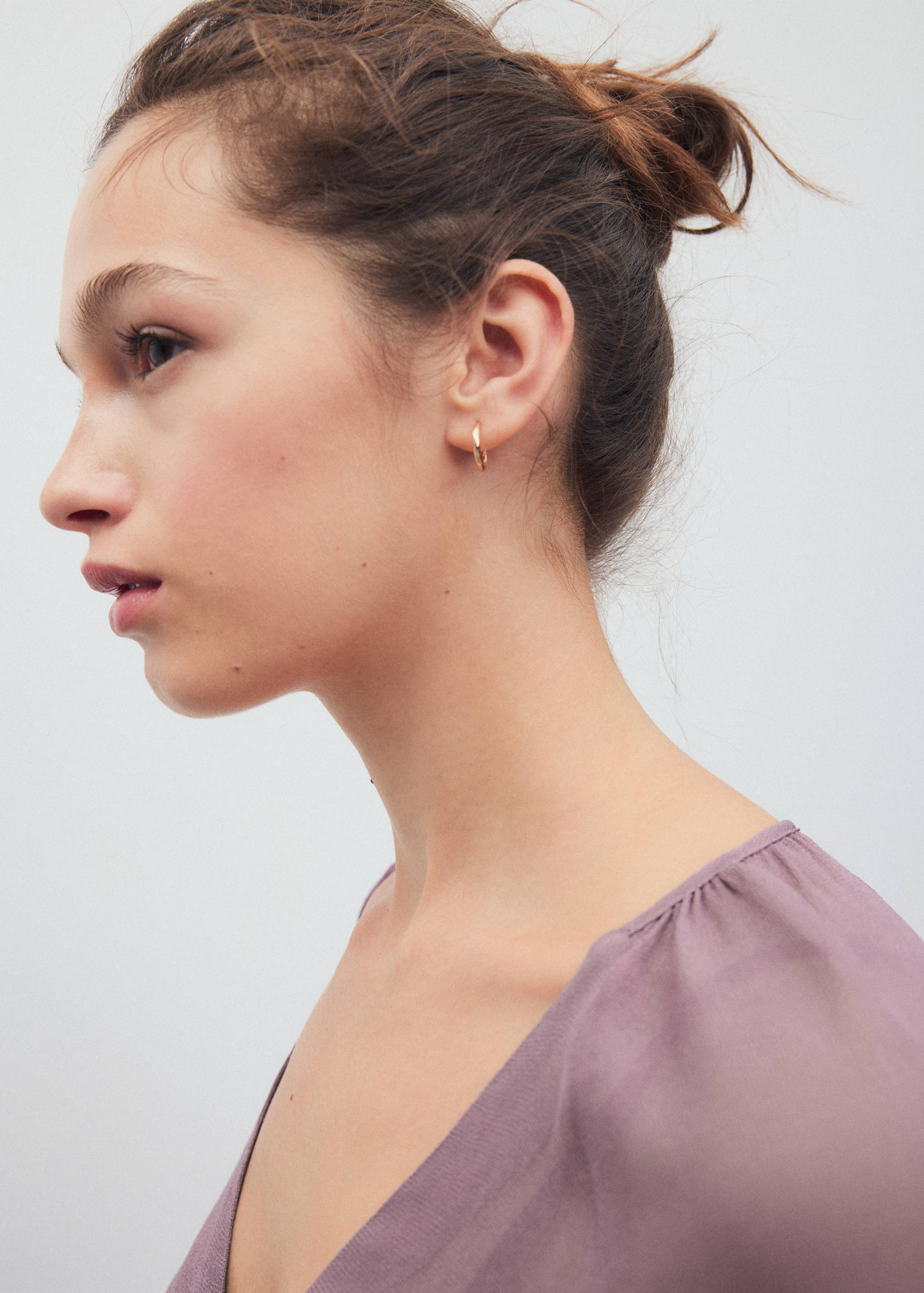 Close-up of a purple V-neck shirt worn by a model.