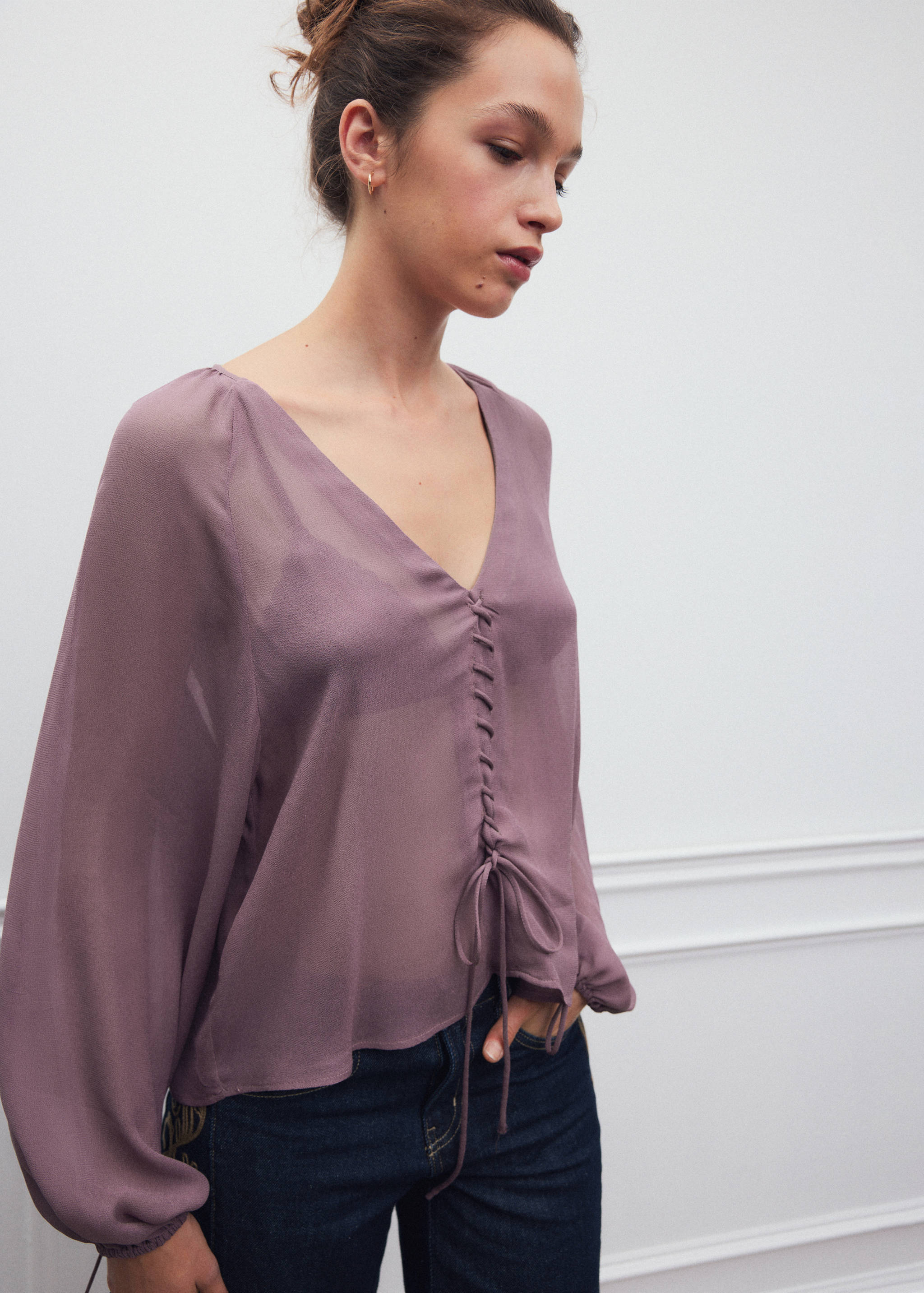 Mauve V-neck shirt with long sleeves and front drawstrings.
