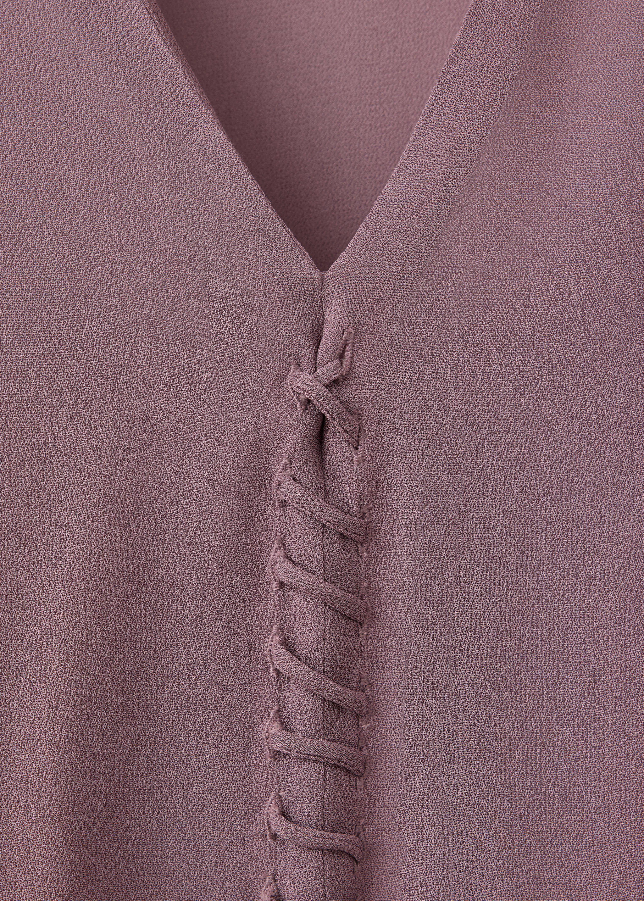 Mauve shirt V-neckline detail with laced front placket.