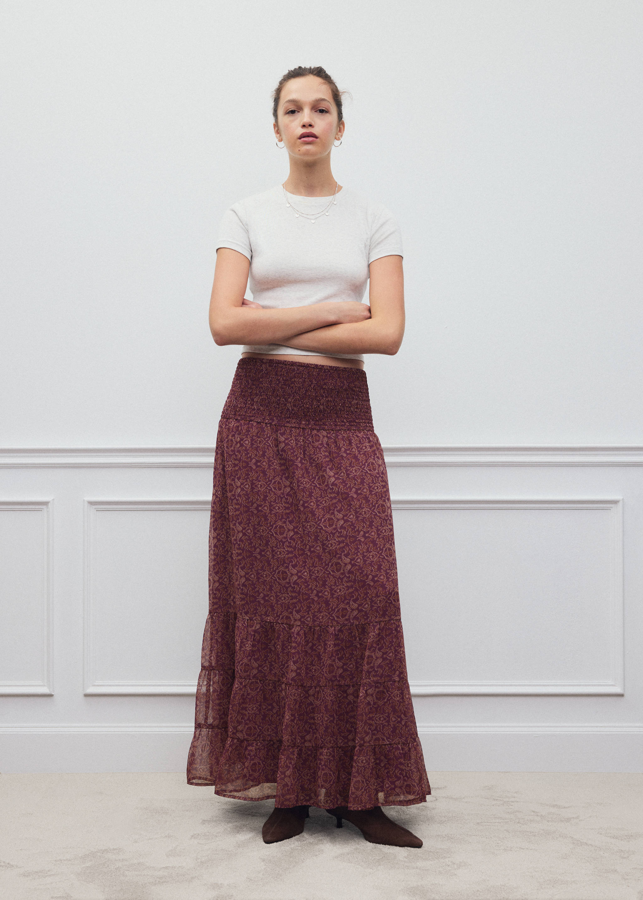 Burgundy printed long skirt with a smocked waistband worn with a white t-shirt