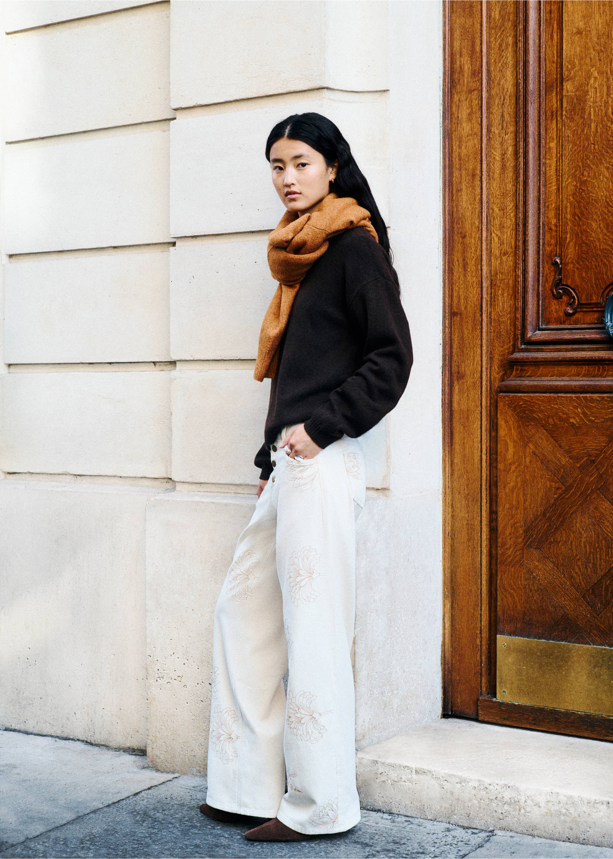 Off-white wide-leg trousers with floral embroidery, worn with a dark brown sweater and scarf., Beige. Ref: 37098280-00.