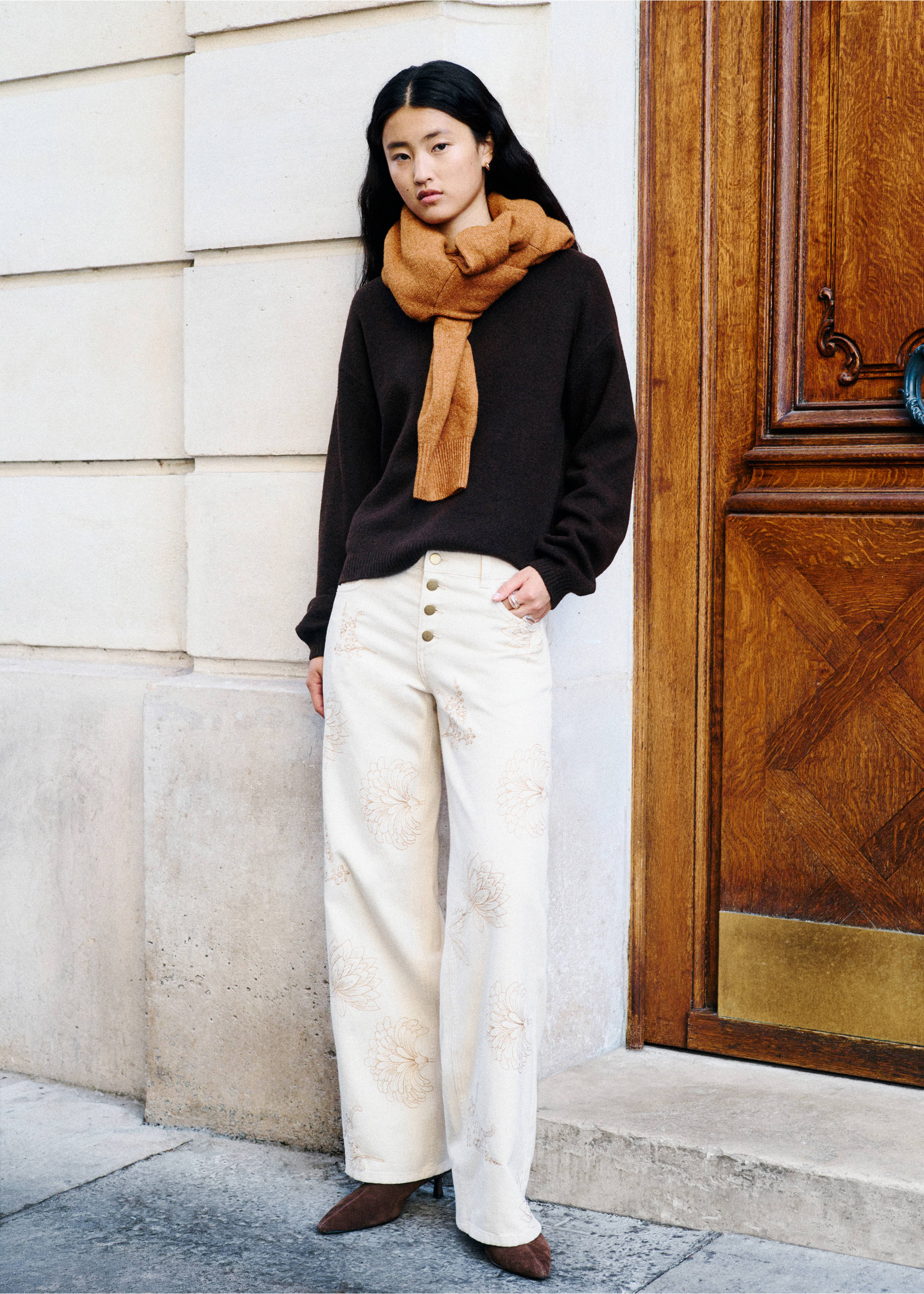 Off-white wide-leg embroidered trousers with a button front, worn with a dark brown sweater., Beige. Ref: 37098280-00.