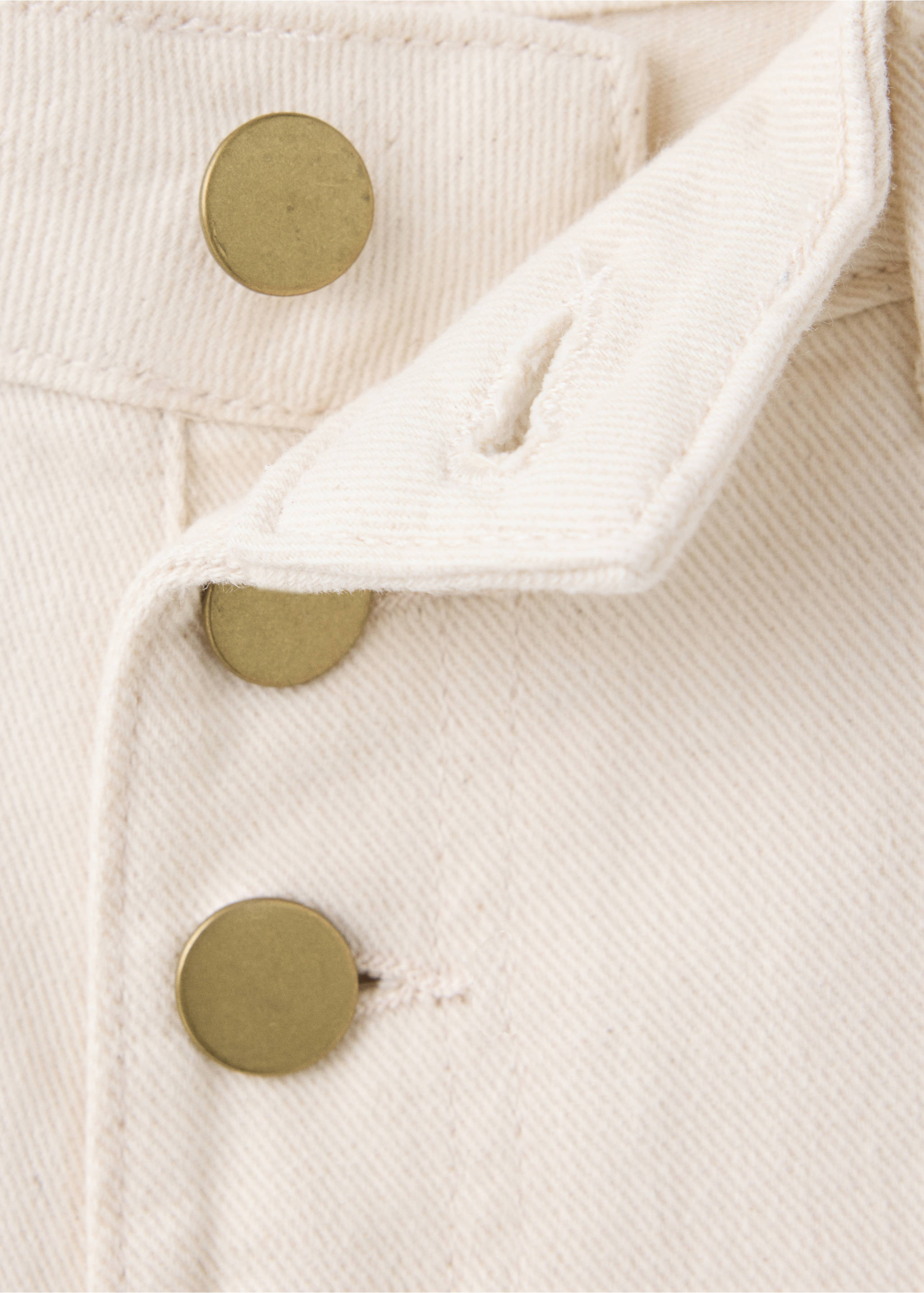 Close-up of off-white denim trousers focusing on the button fly., Beige. Ref: 37098280-00.