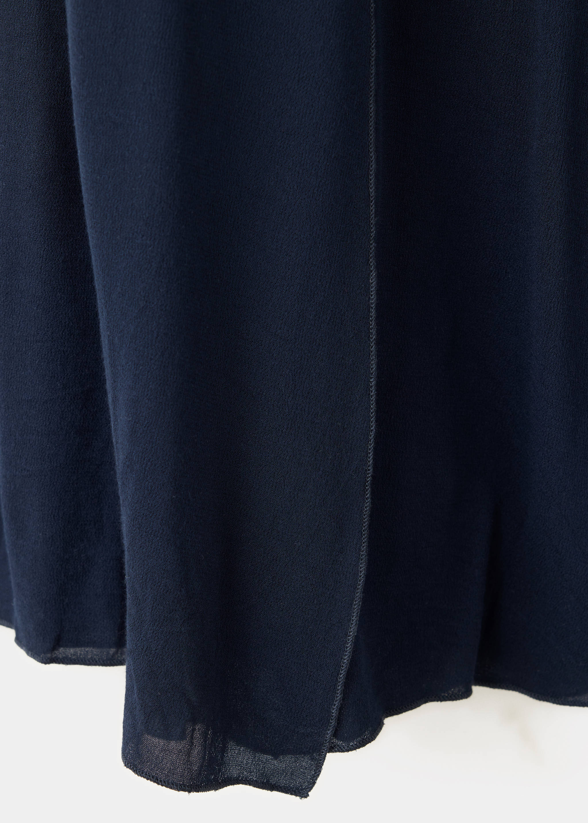 Close-up of a navy blue skirt fabric texture.