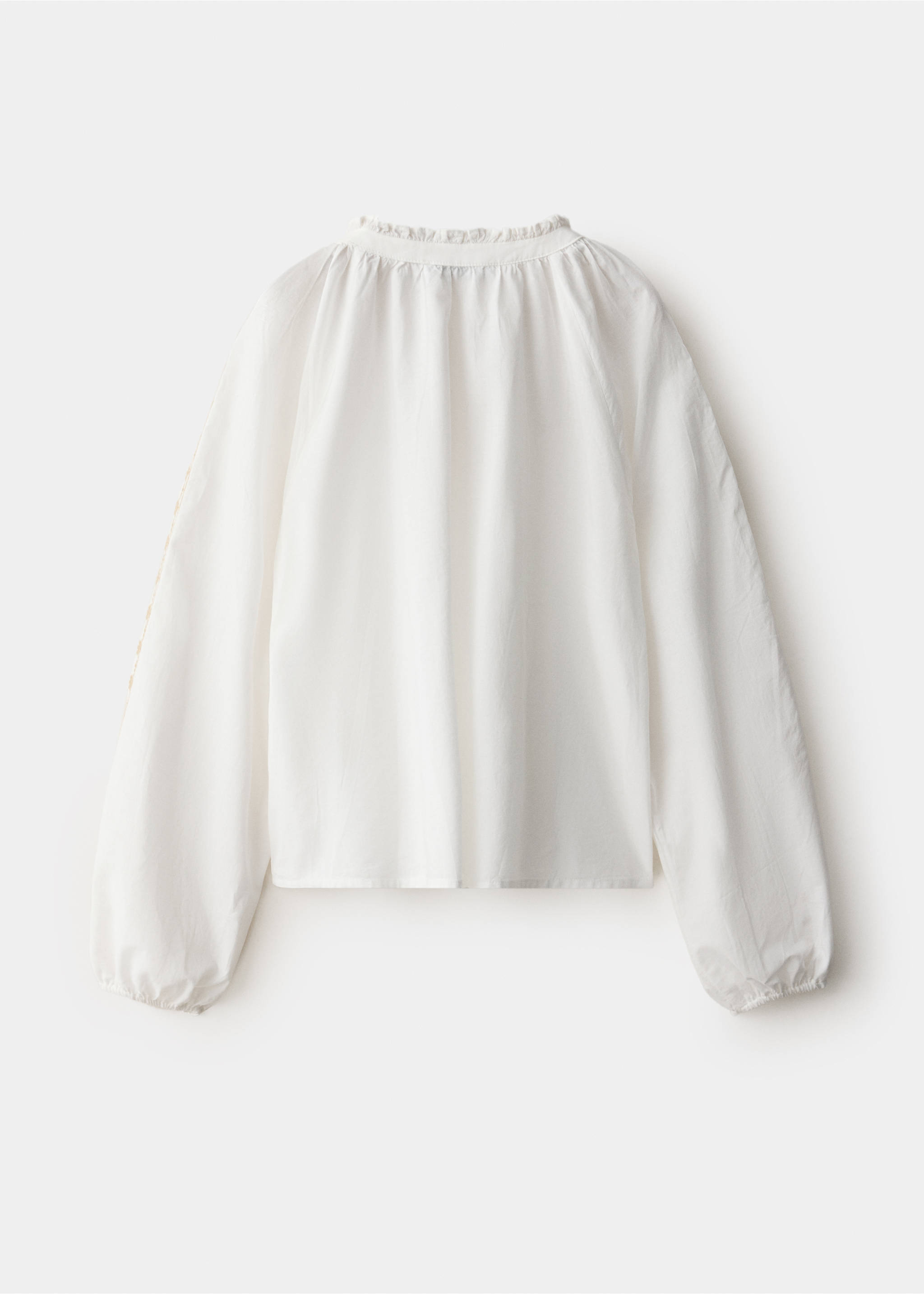 White shirt with long sleeves and a ruffled neckline, back view., White. Ref: 37098634-00.