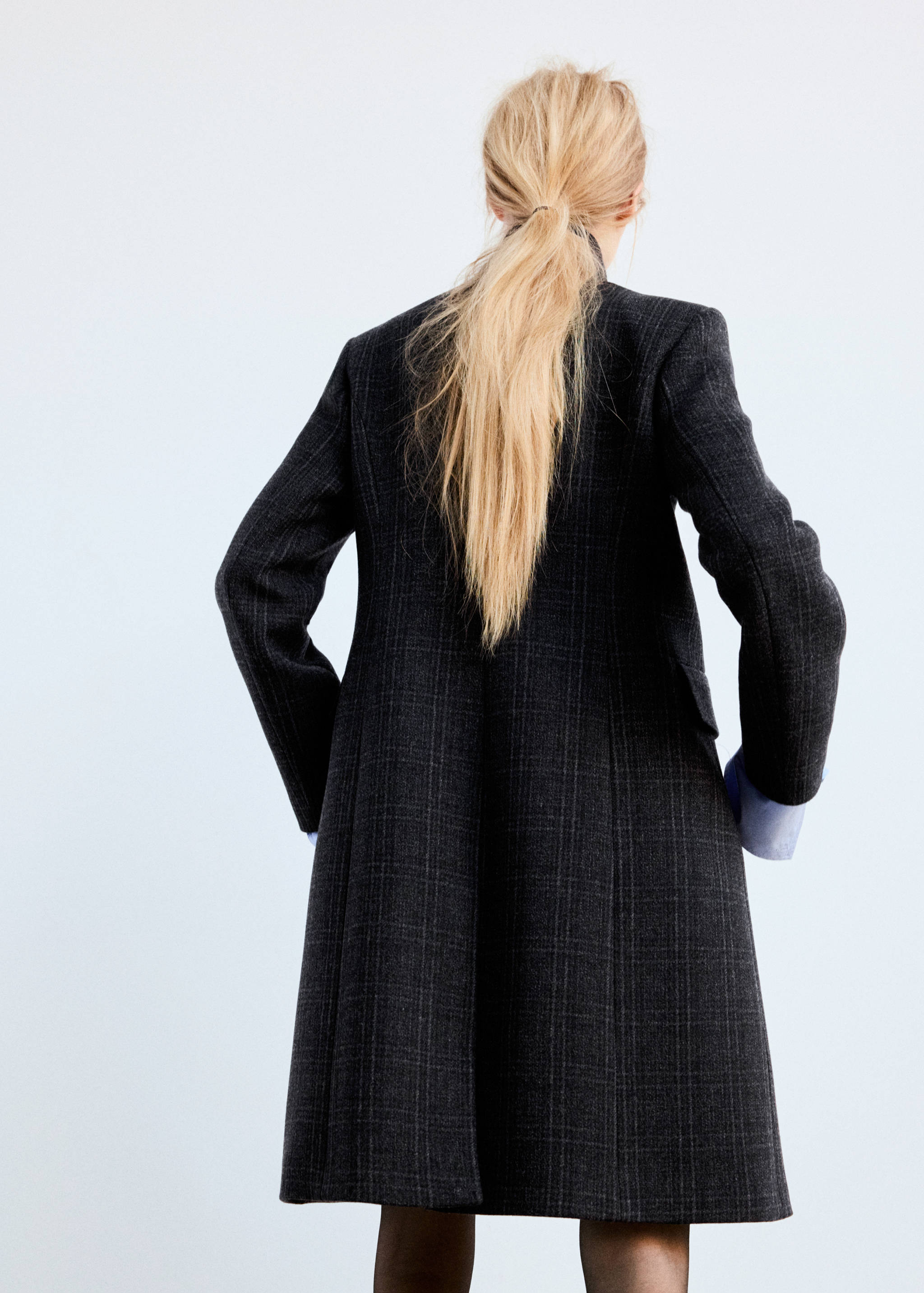 Dark grey checked long coat shown from the back.