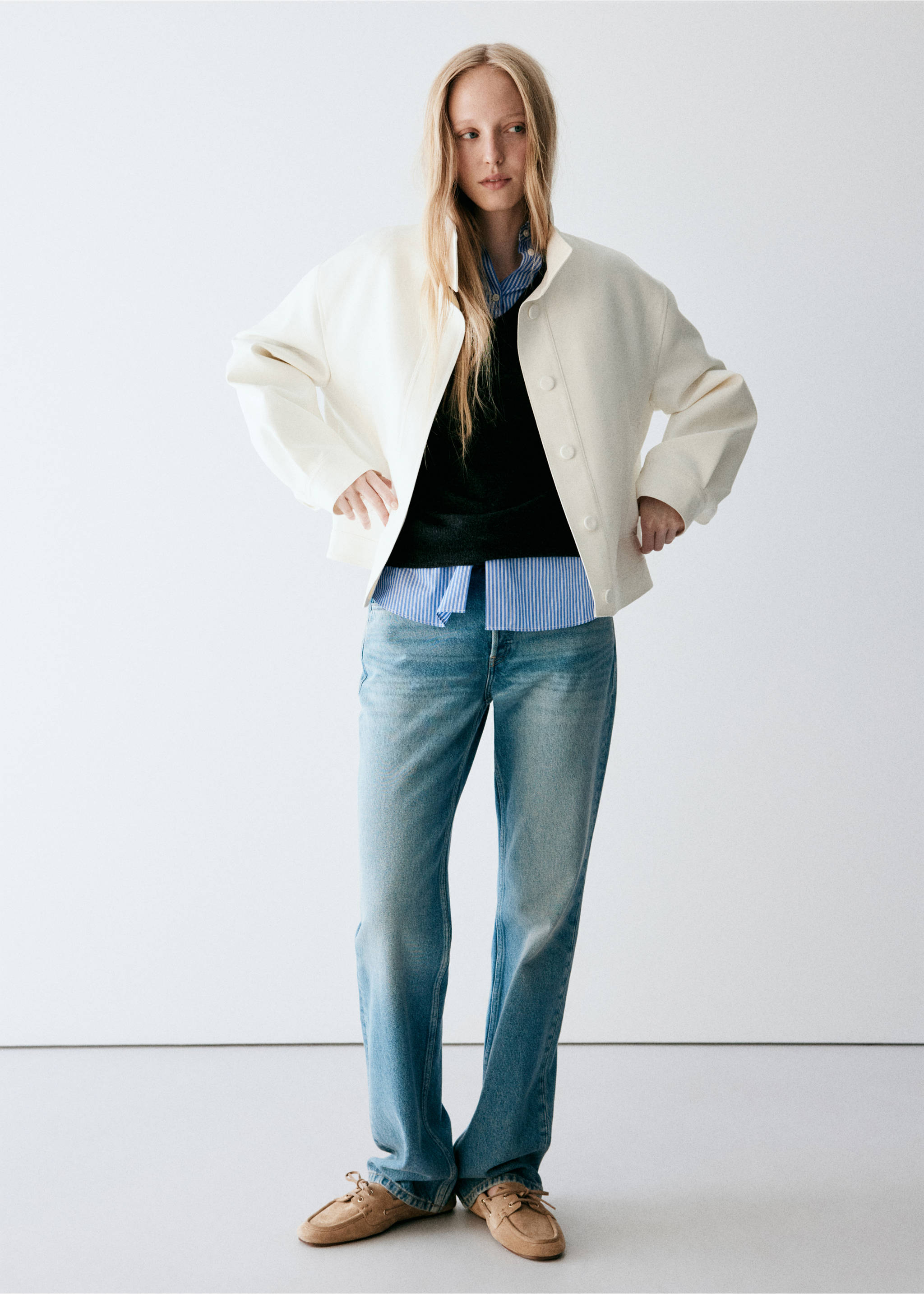 White cropped jacket with a high collar, worn with layered tops, blue jeans and tan shoes., Off White. Ref: 37098640-00.