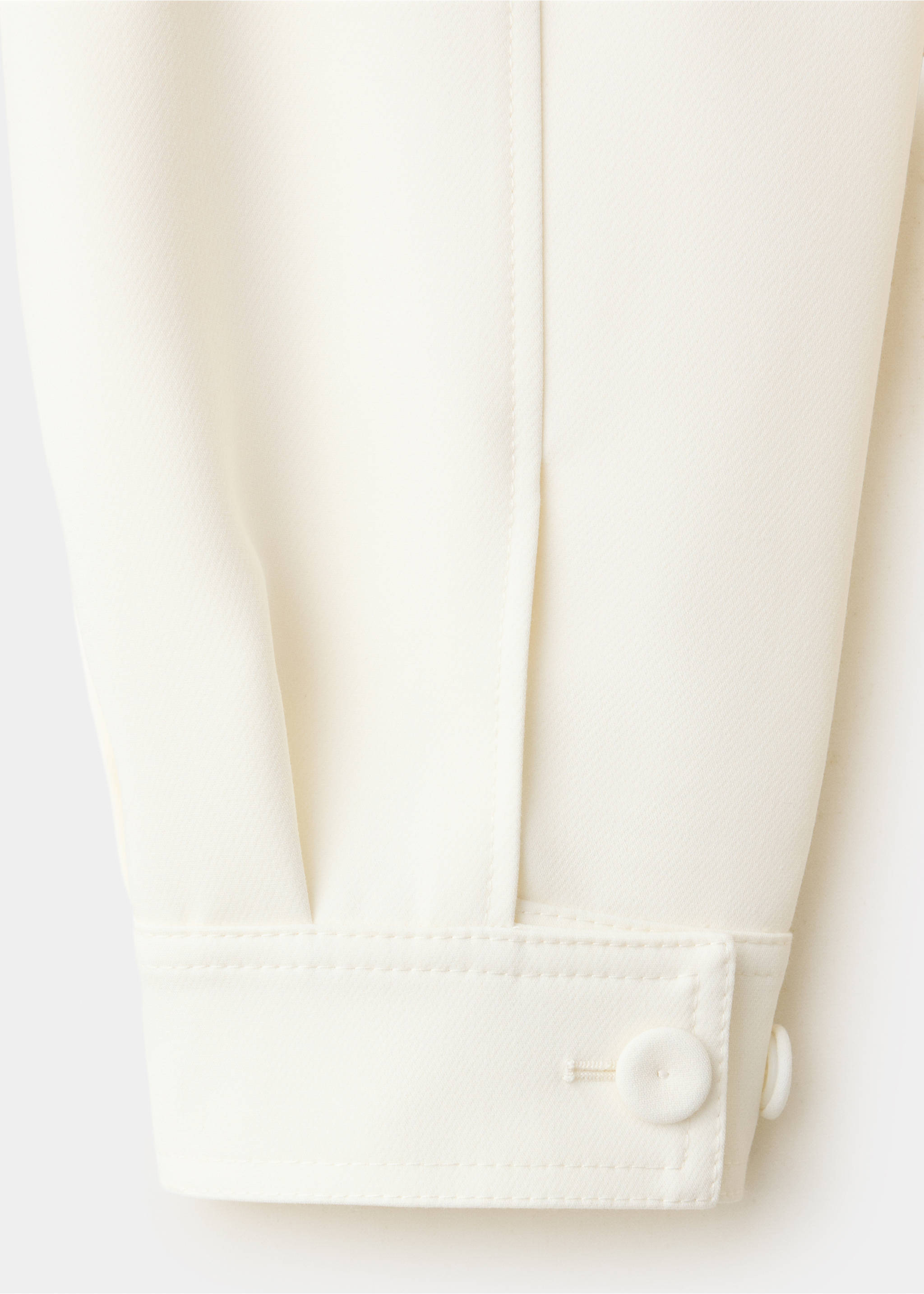 Close-up of off-white jacket sleeve with buttoned cuff., Off White. Ref: 37098640-00.