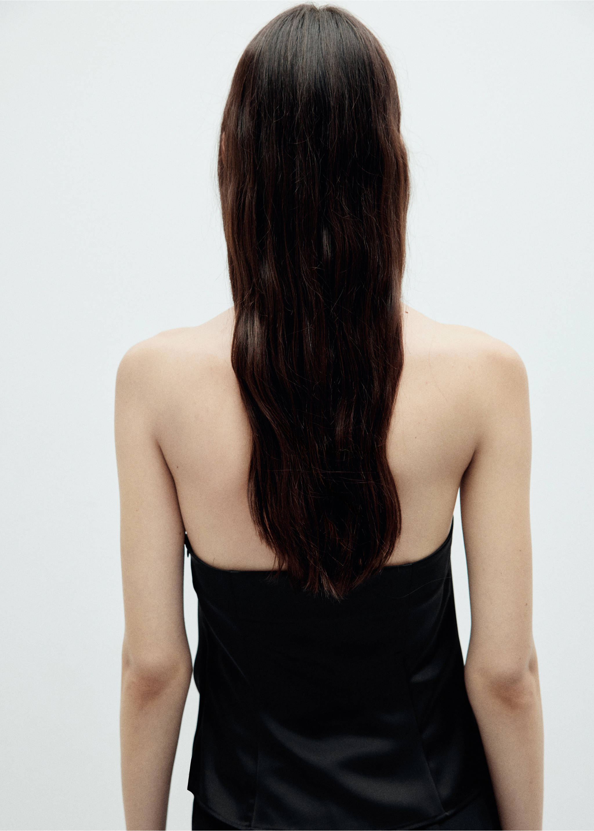 Back view of a strapless black top worn by a model., Black. Ref: 37099116-00.