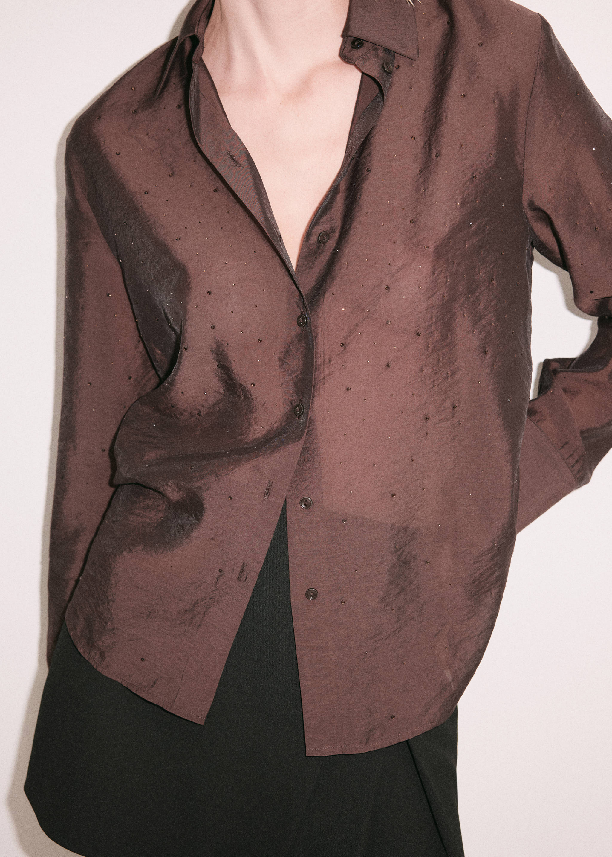 Brown long-sleeve button-up shirt with subtle embellishments.