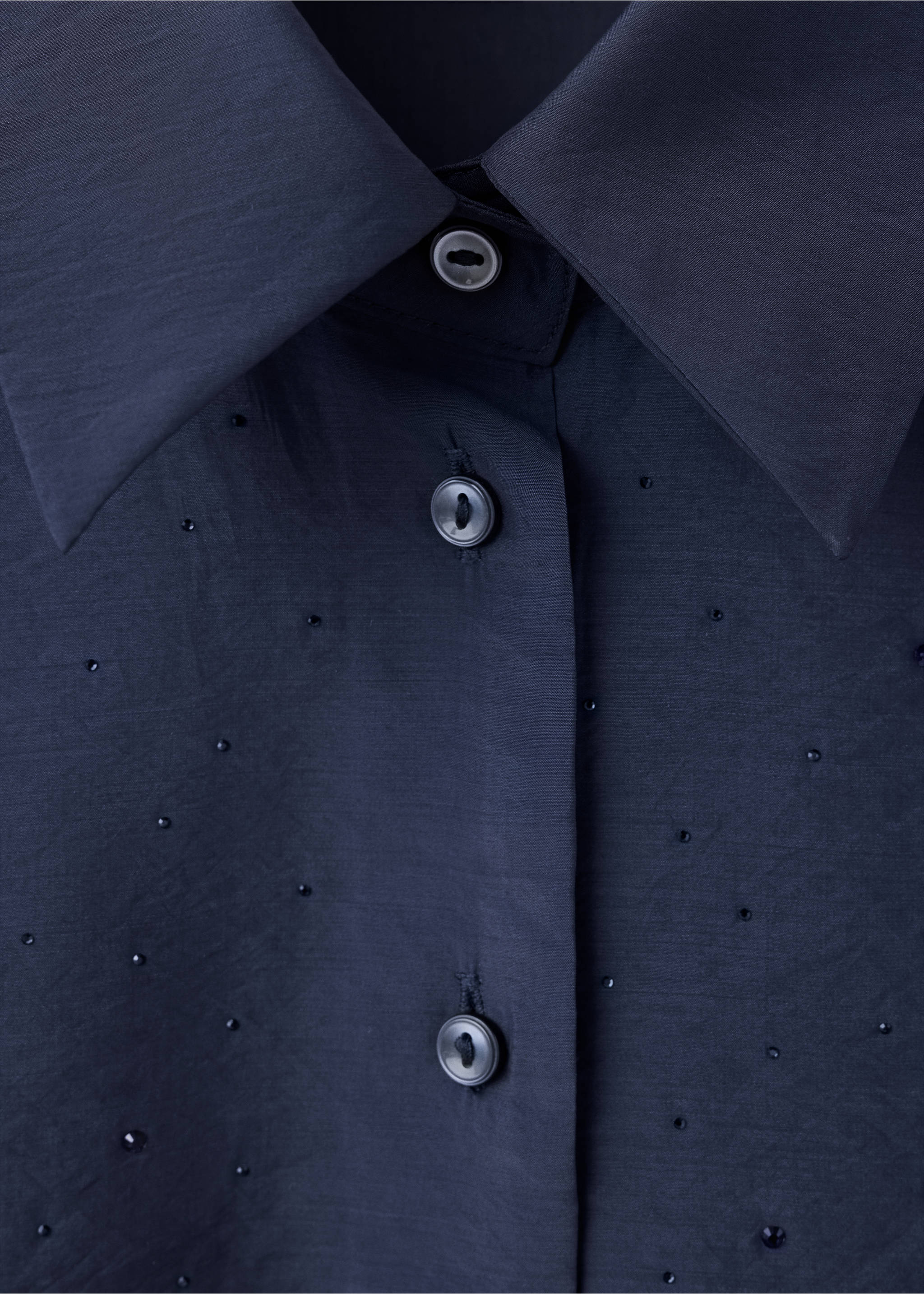 Dark navy blue shirt detail with a pointed collar and scattered tonal rhinestones., Blue. Ref: 37099118-00.