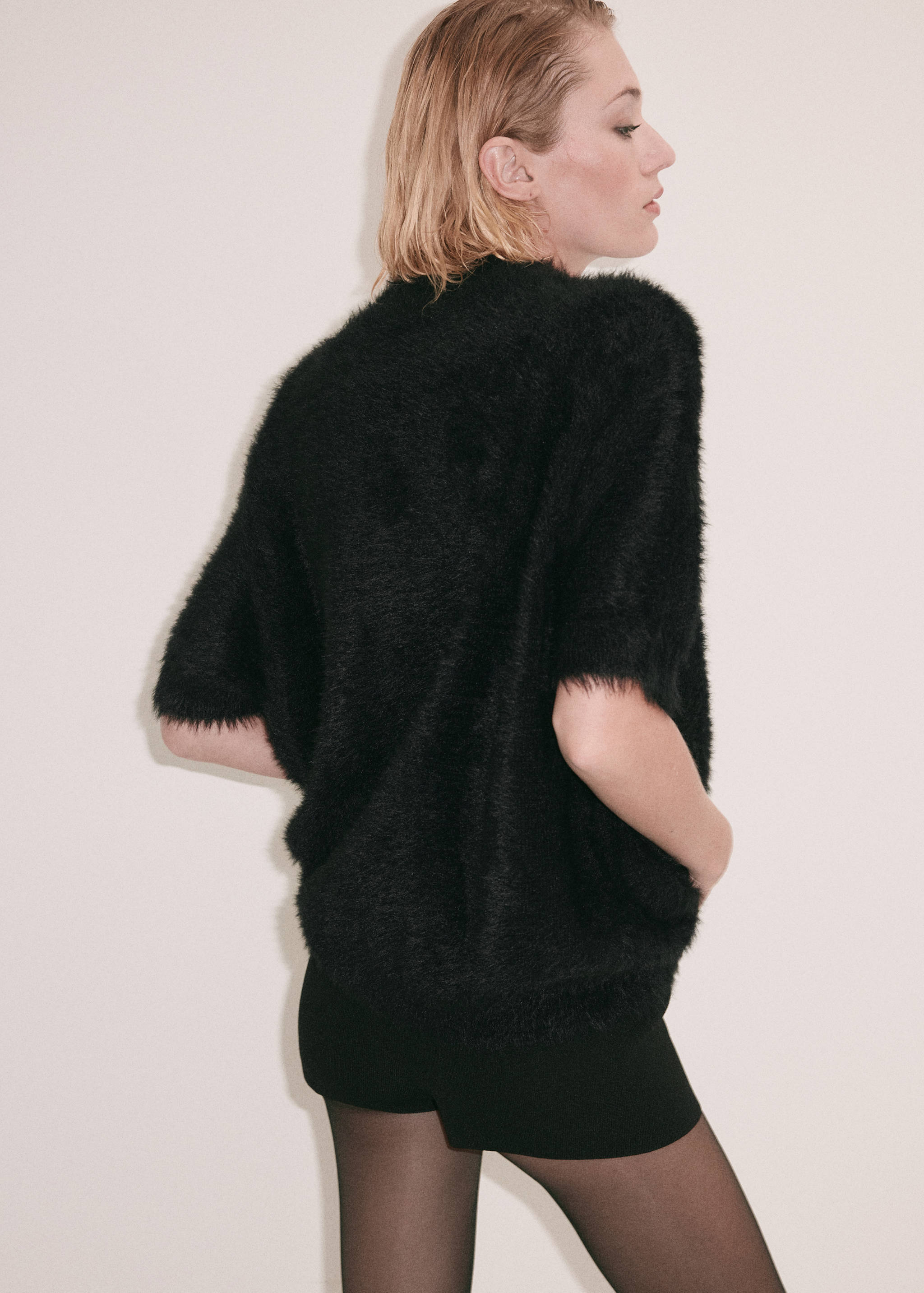Black textured waistcoat with short sleeves, shown from the back.