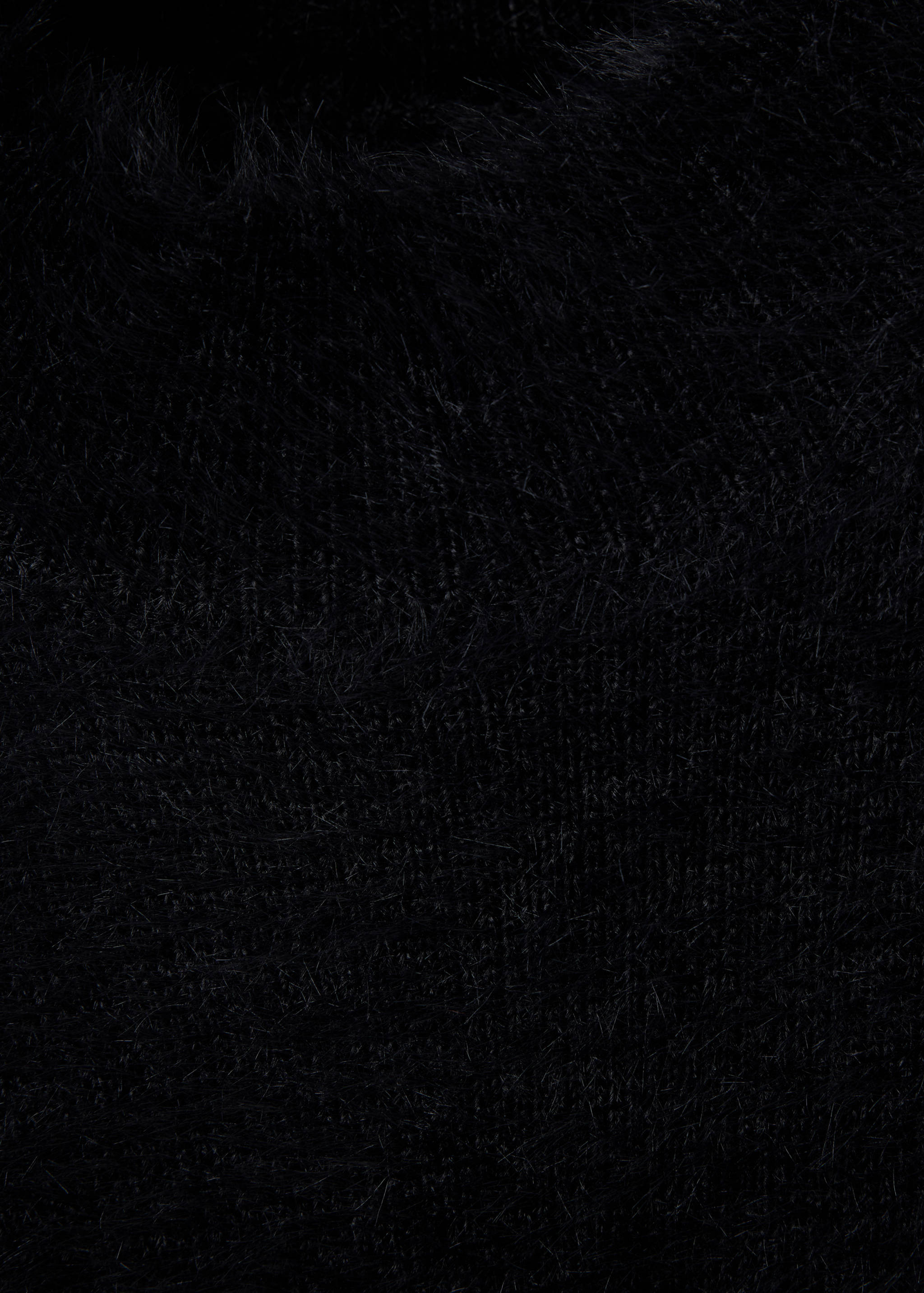 Close-up of the black knitted waistcoat's textured fuzzy yarn.