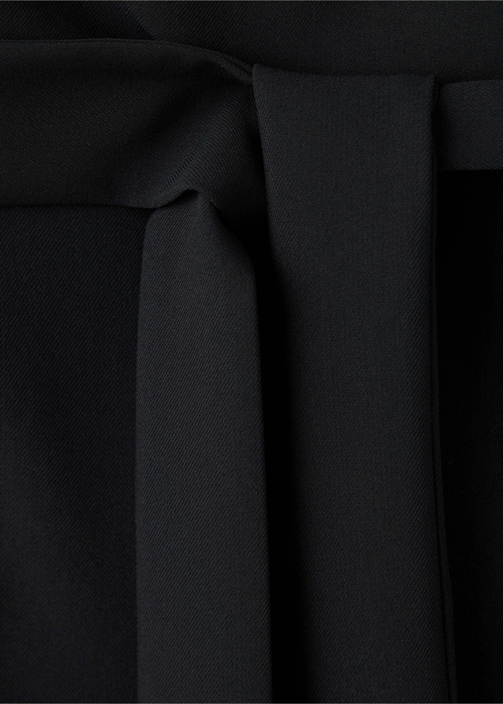 Close-up of a black jumpsuit waist with a matching self-tie belt., Black. Ref: 37099121-00.