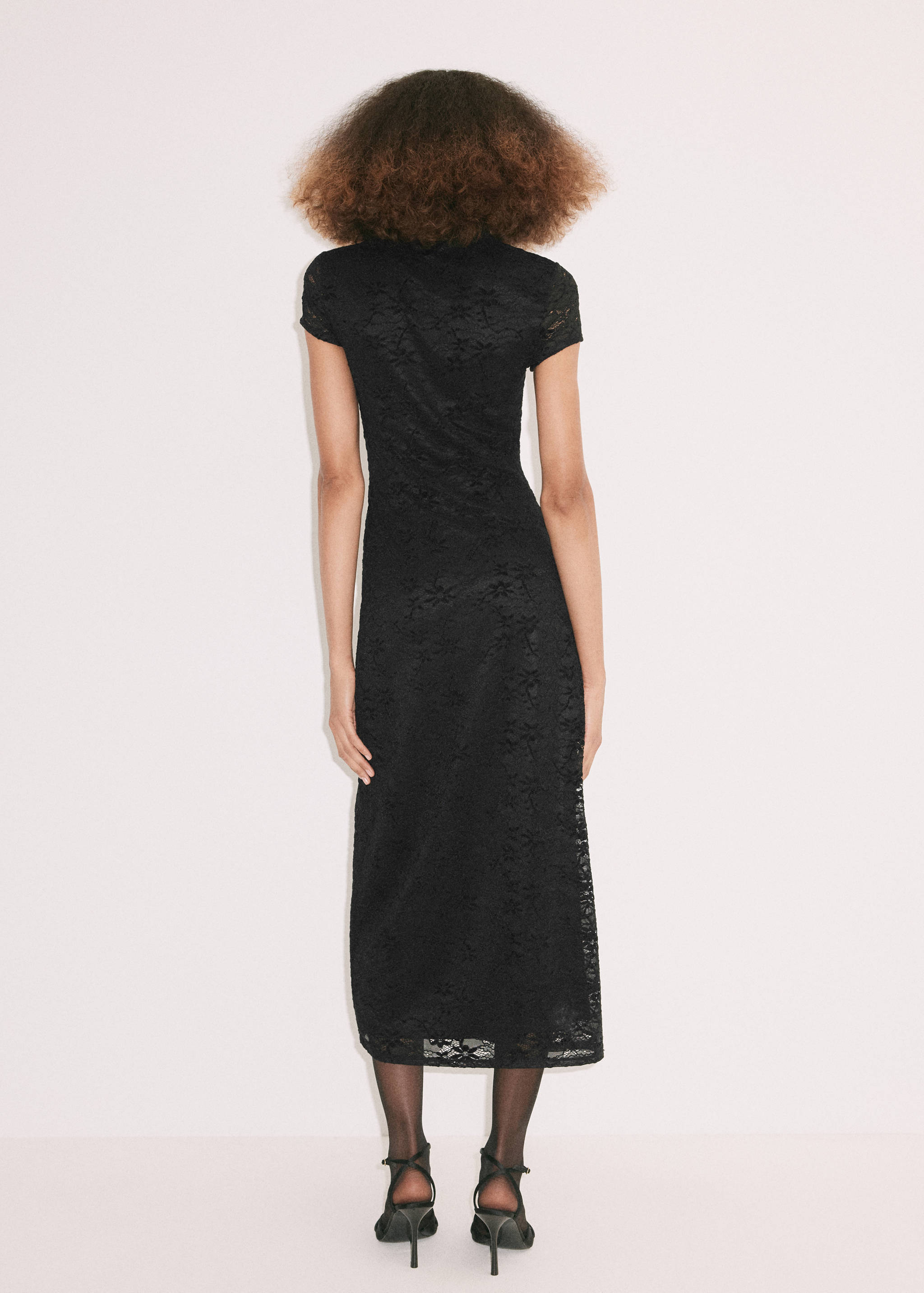 Back view of a black lace midi dress with short sleeves.