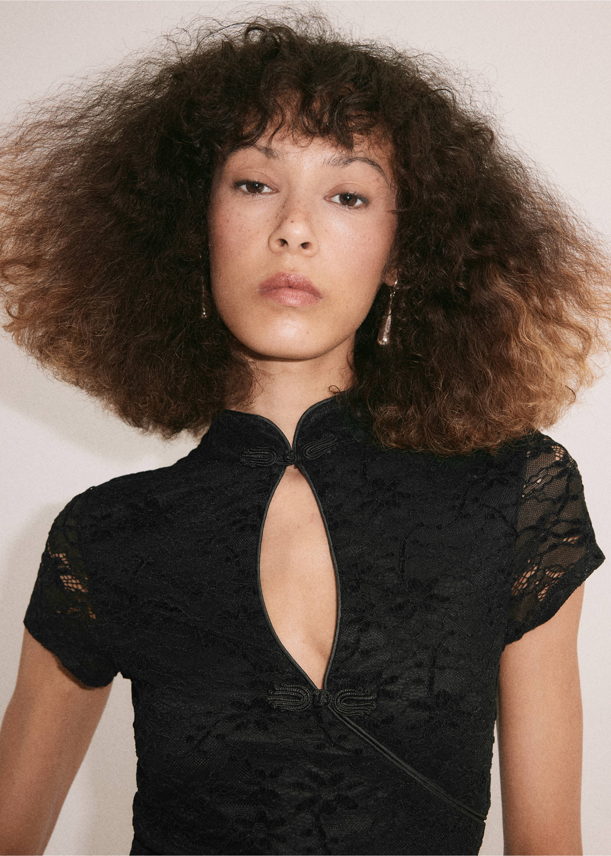 Black lace dress with a mandarin collar, keyhole cutout, and frog closures., Black. Ref: 37099129-00.