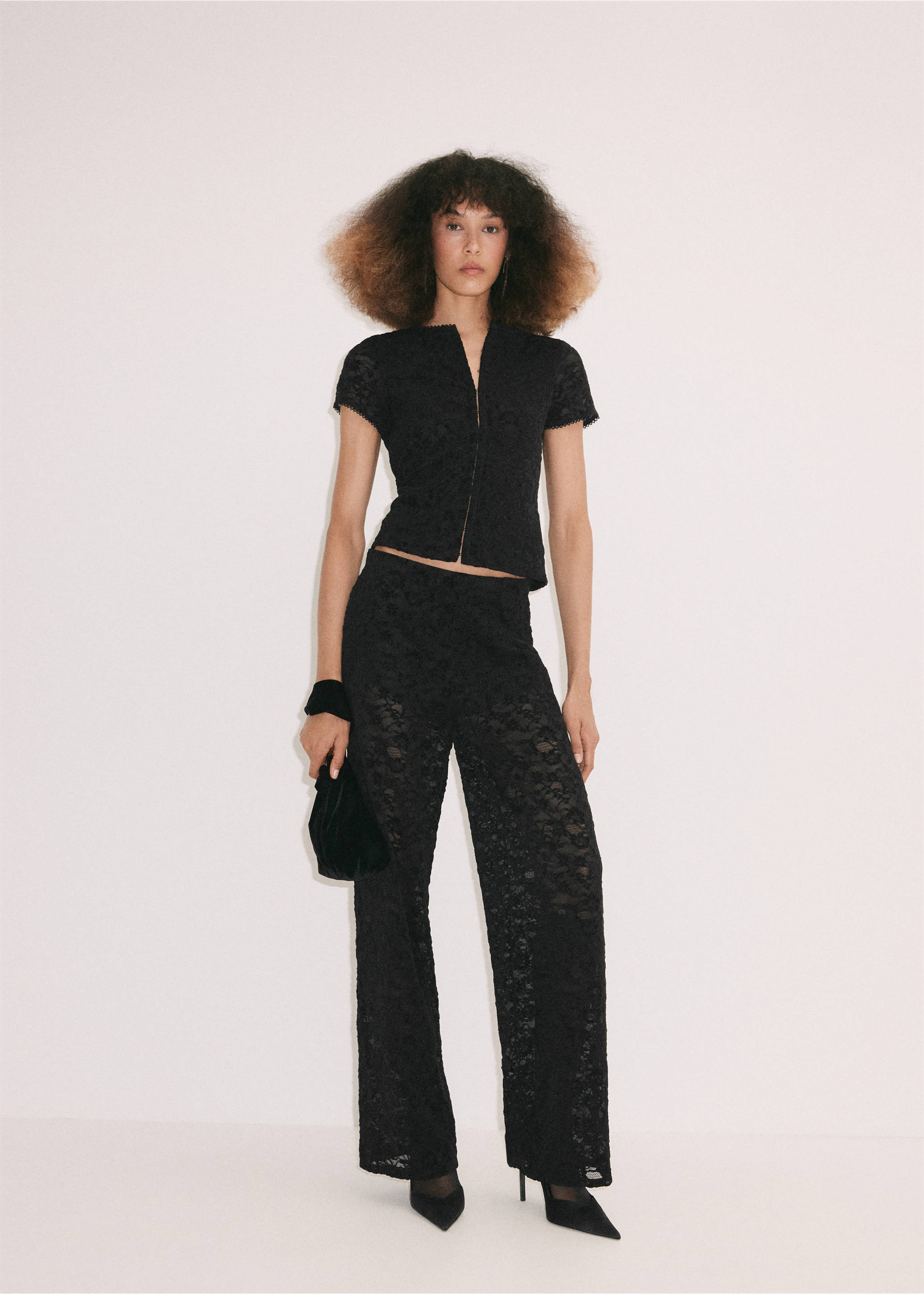 Black lace trousers, worn with a matching short-sleeved top and black accessories., Black. Ref: 37099132-00.