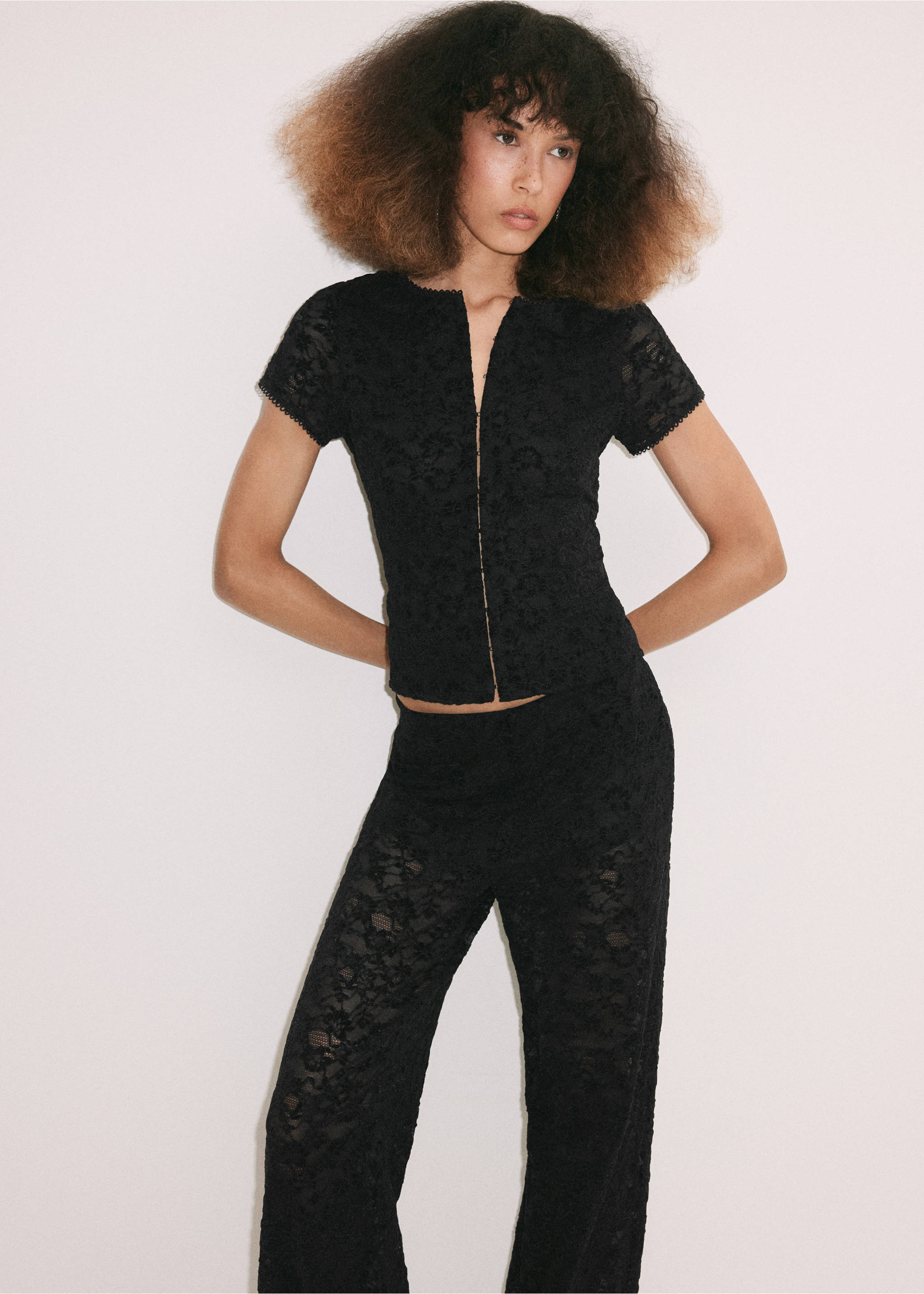 Black lace trousers, shown with a matching short-sleeved top., Black. Ref: 37099132-00.