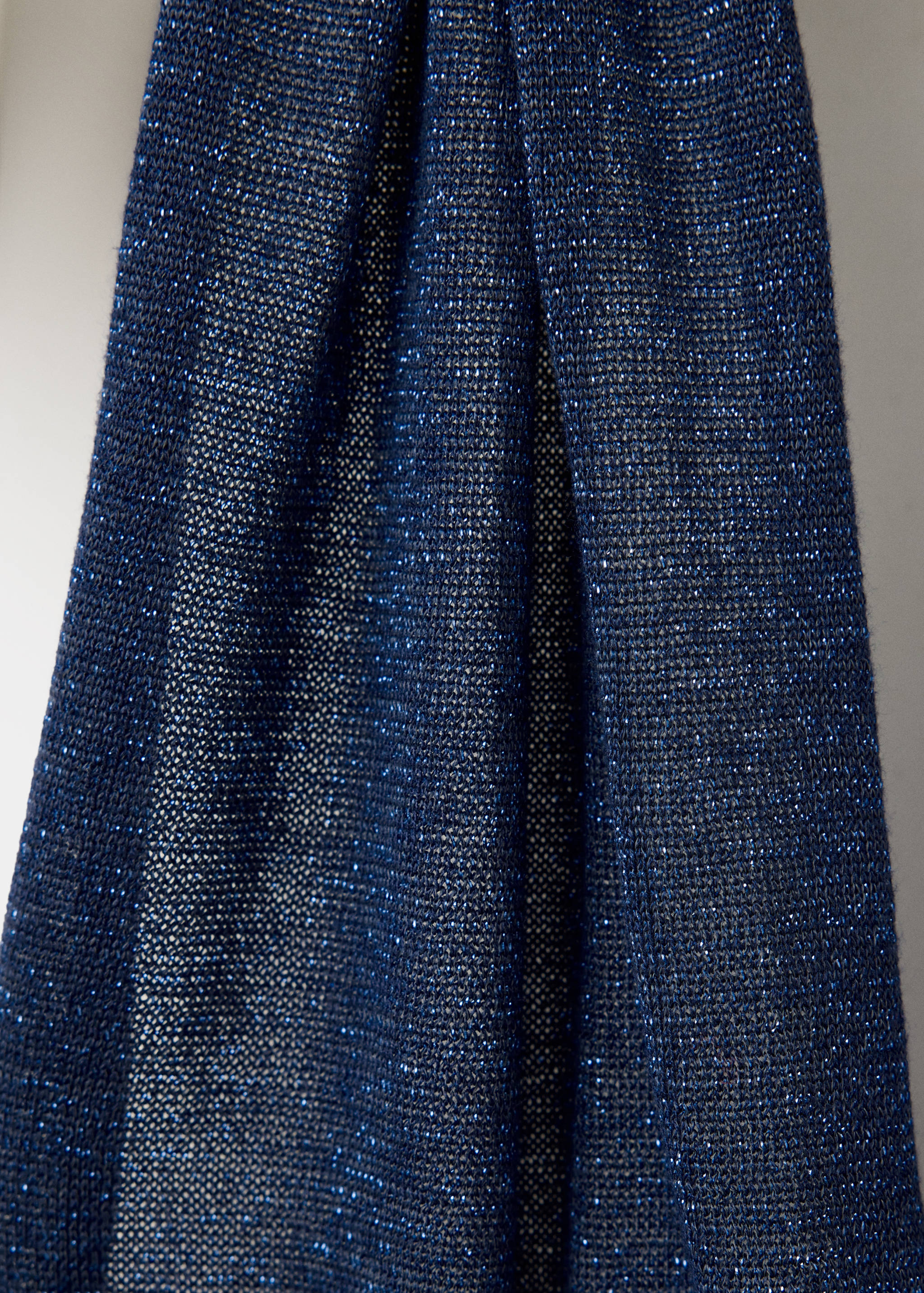 Close-up of a navy blue metallic knit top with a sparkle finish.