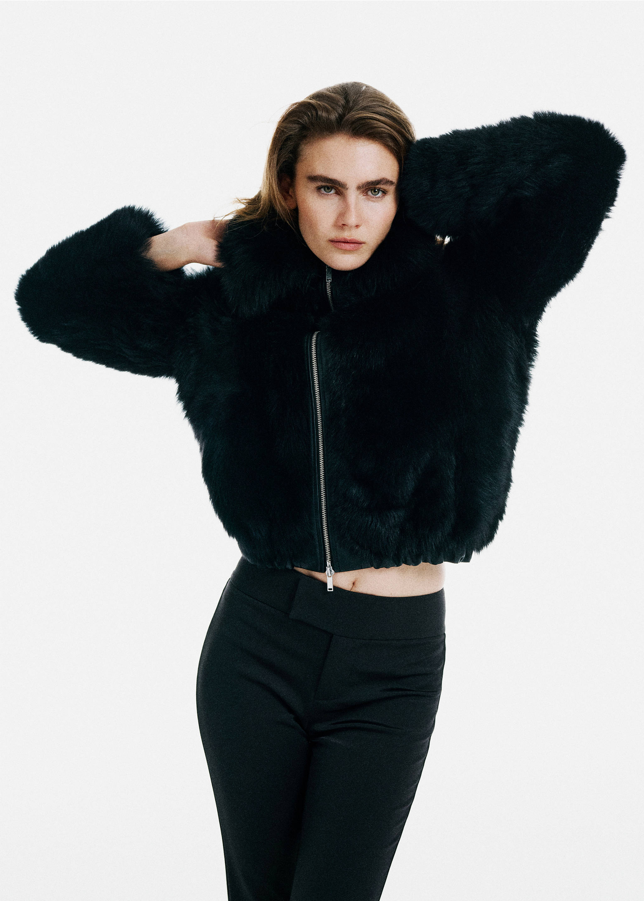 Black faux-fur cropped jacket with a high collar and a silver front zip.