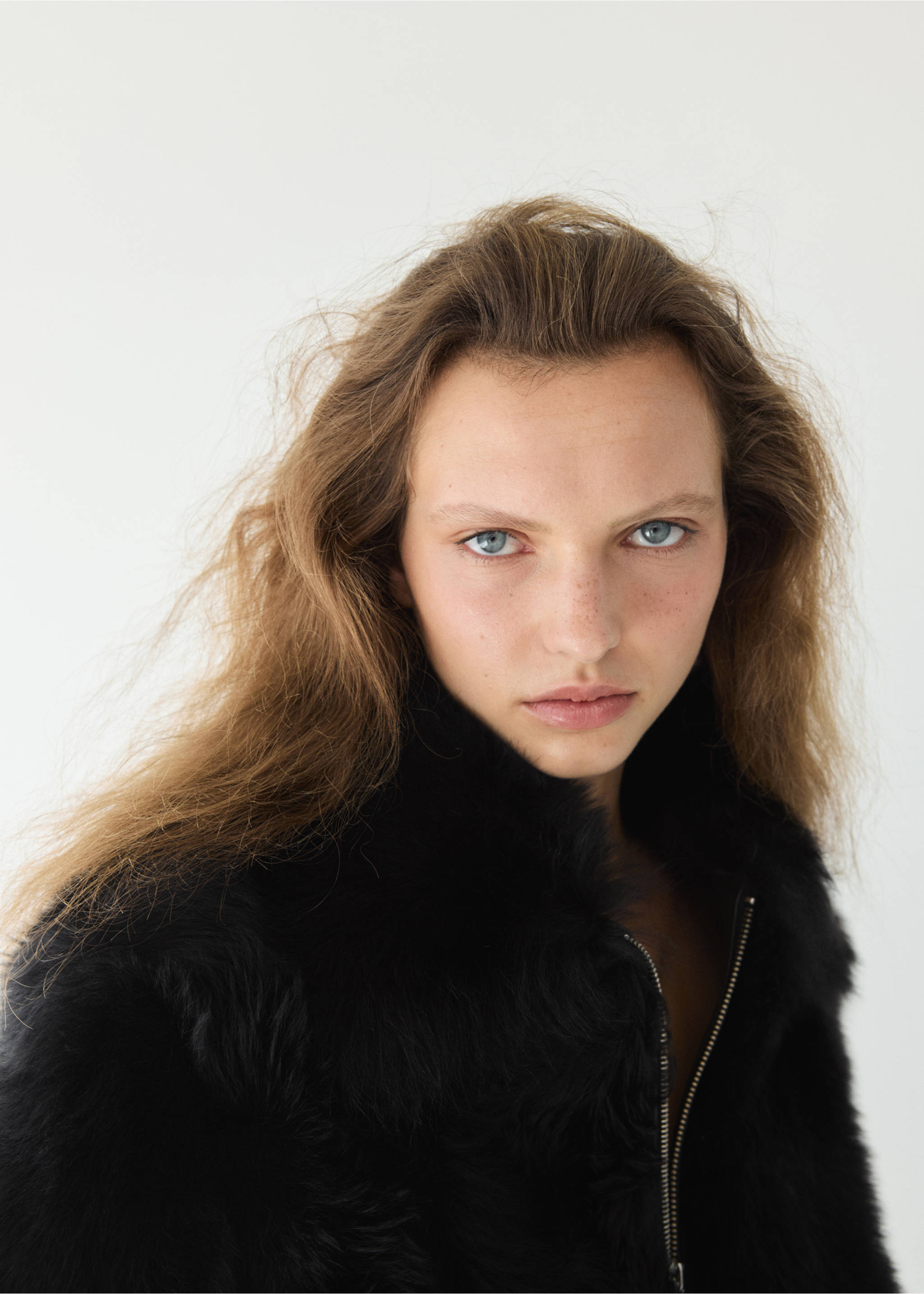 Close-up of a model wearing a black faux-fur jacket., Black. Ref: 37099136-00.