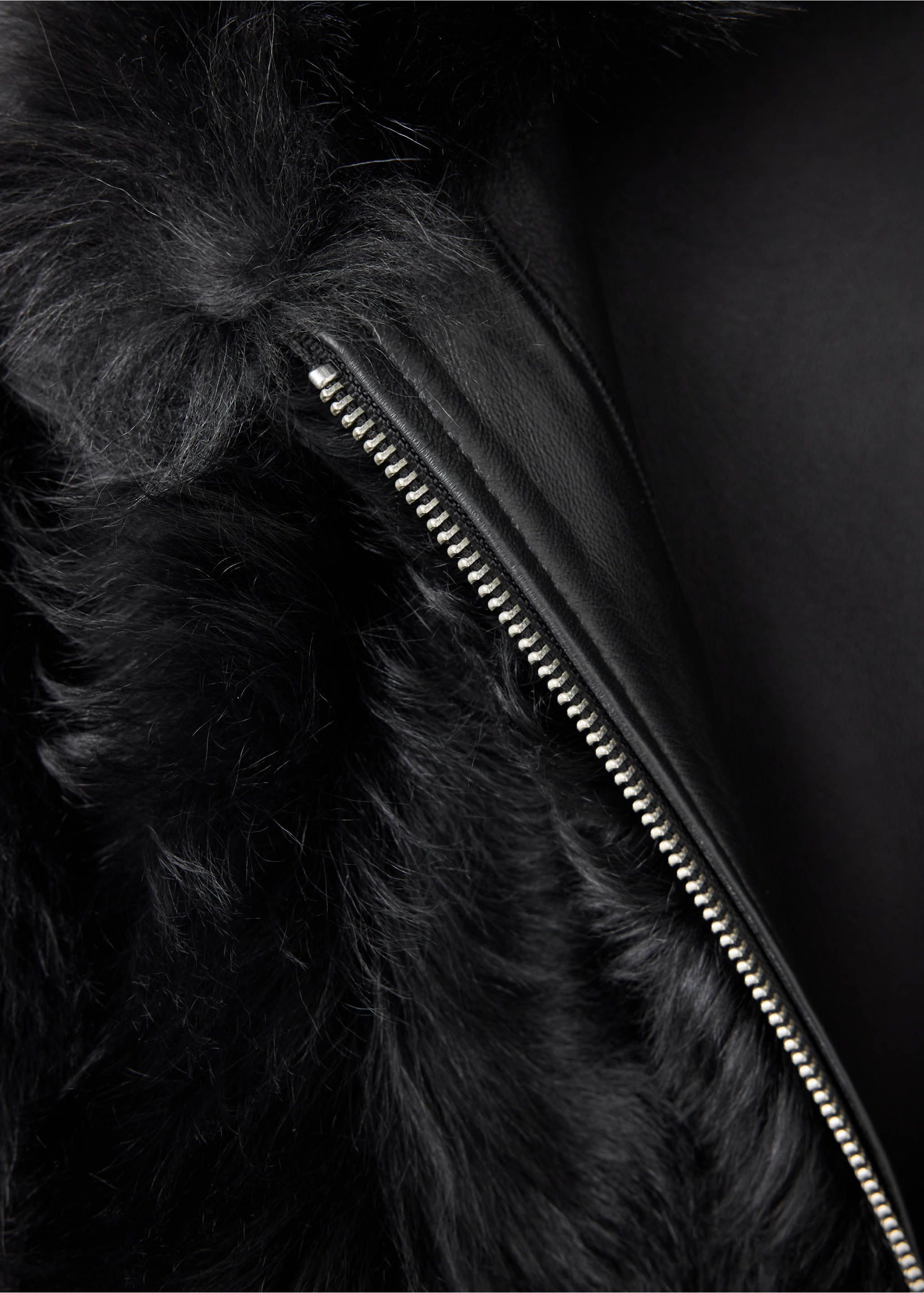 Close-up of a black jacket with faux-fur collar and zip detail., Black. Ref: 37099136-00.