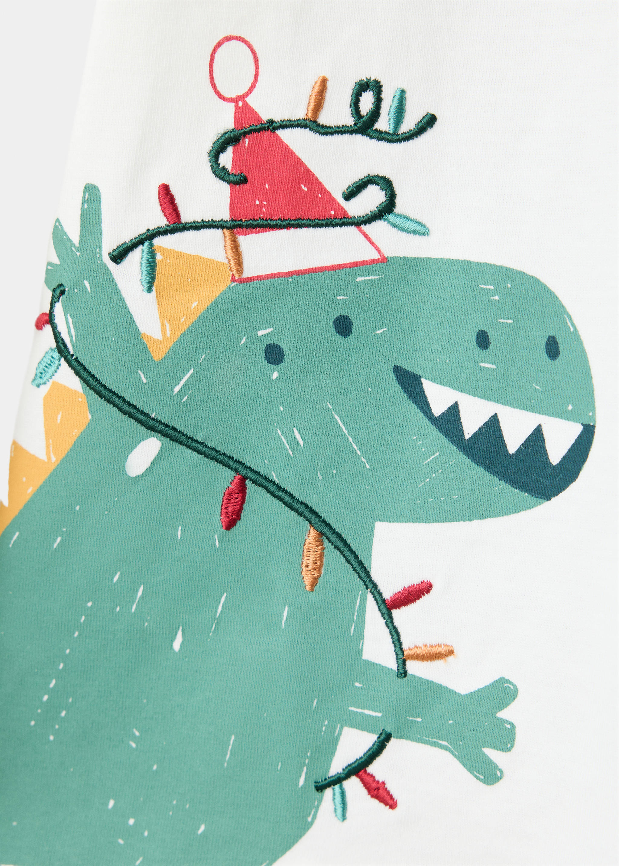 White children's t-shirt with a green dinosaur graphic wearing a party hat.