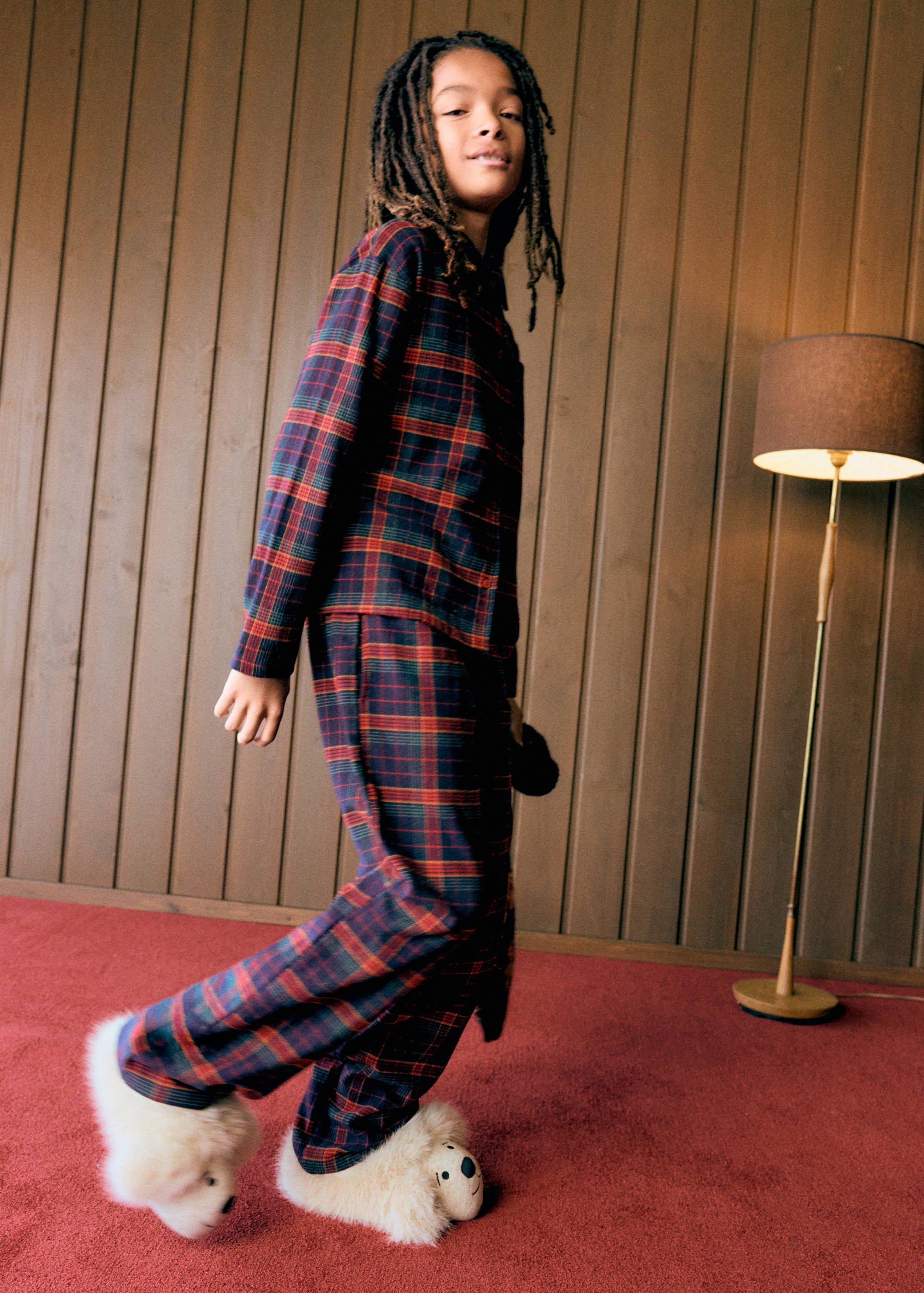 Kids' red and green plaid pyjama set featuring a button-down shirt and matching trousers.