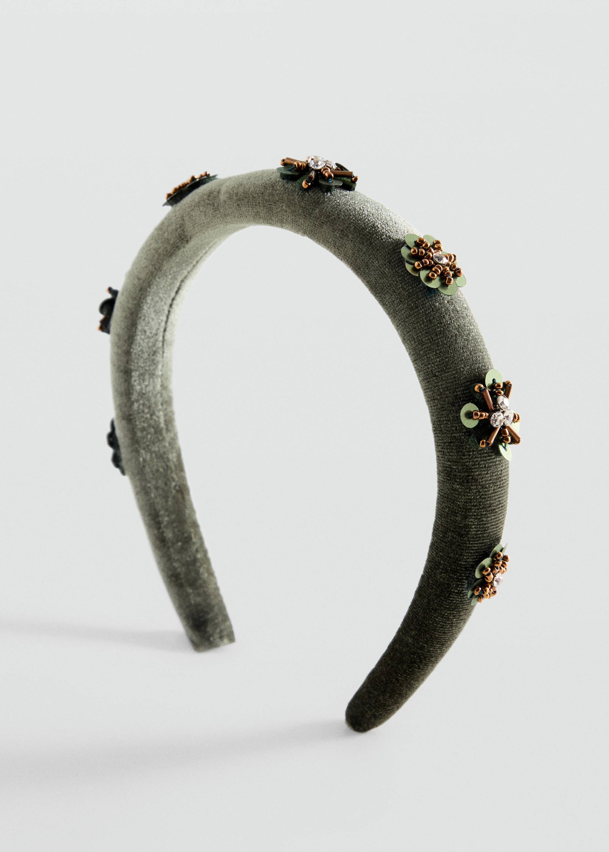 Sage green velvet headband with sequin and rhinestone floral details in a three-quarters view.
