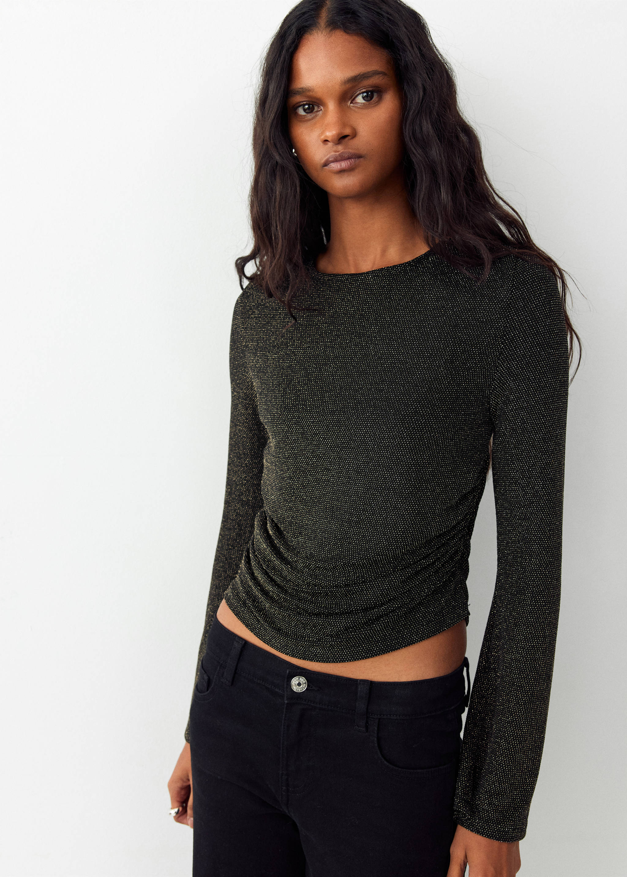 Black metallic shimmery long-sleeved t-shirt with ruched side detail and rounded neckline.