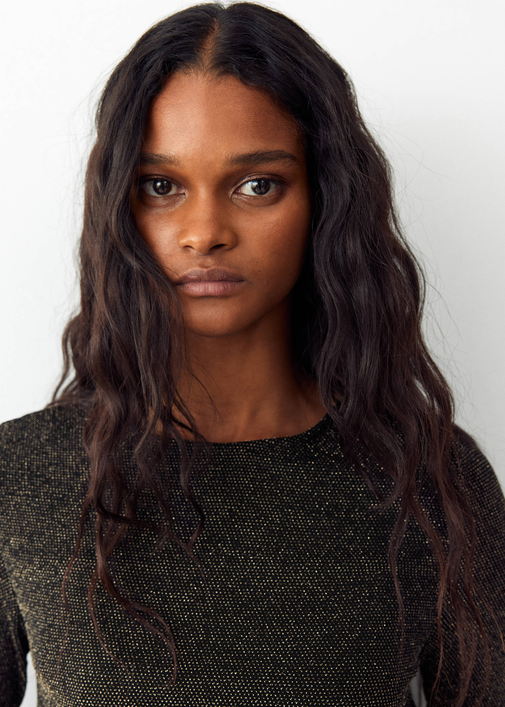 Close-up of a black metallic t-shirt with a round neckline.
