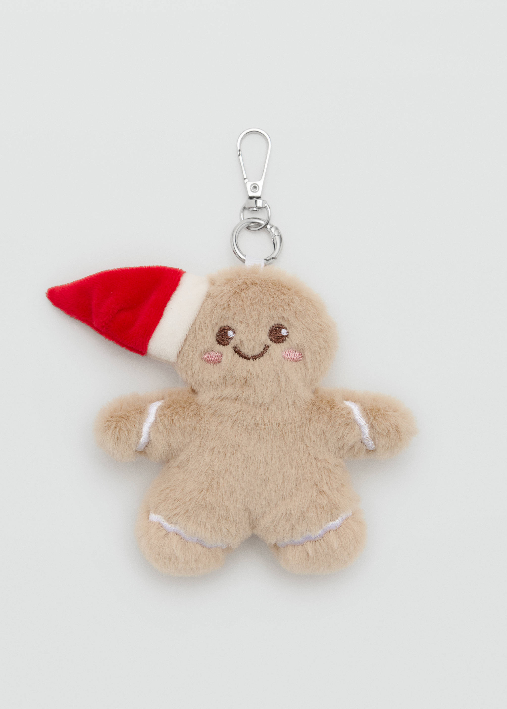Plush gingerbread man keychain wearing a Santa hat.
