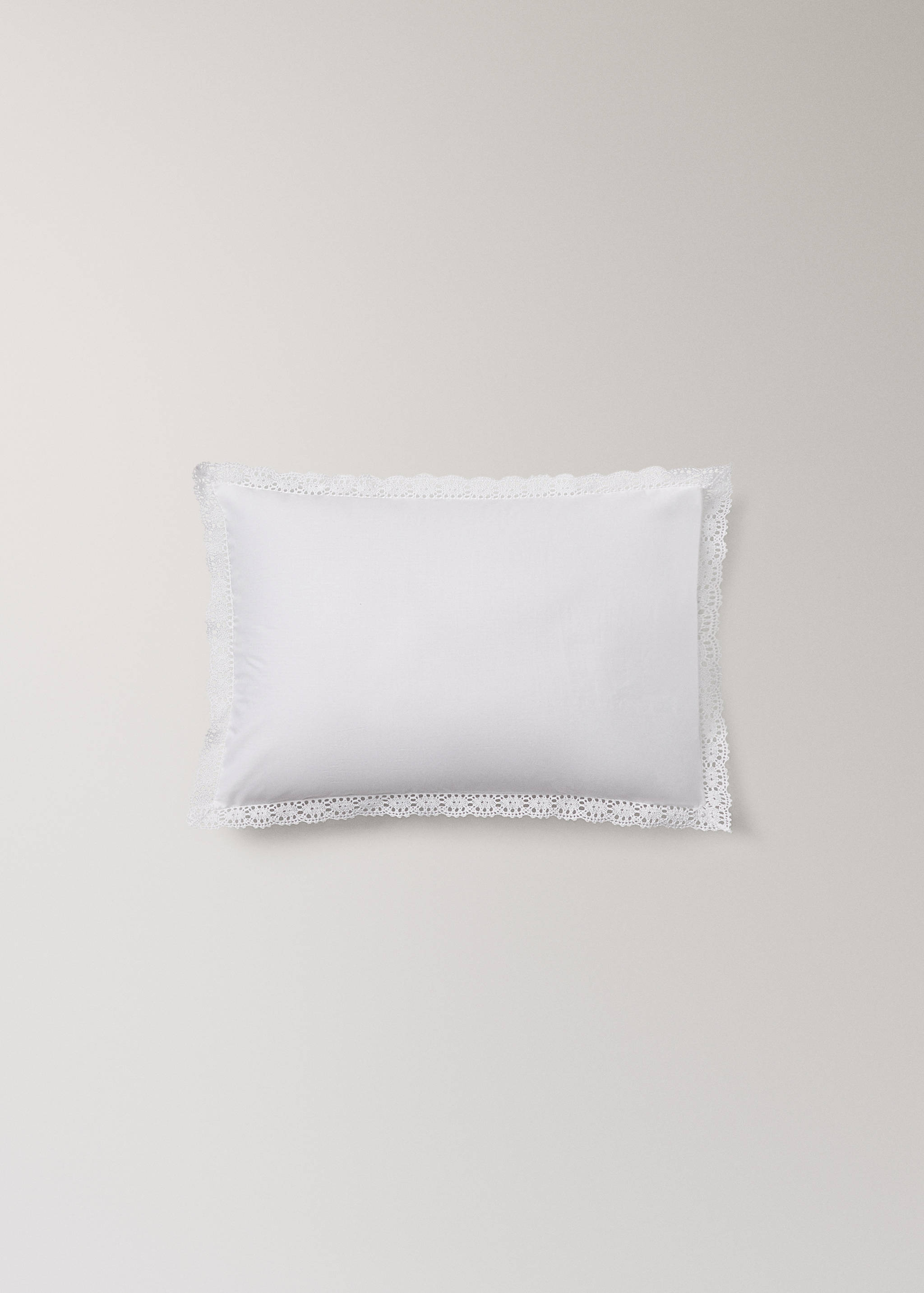 White cushion cover featuring a wide decorative lace border.