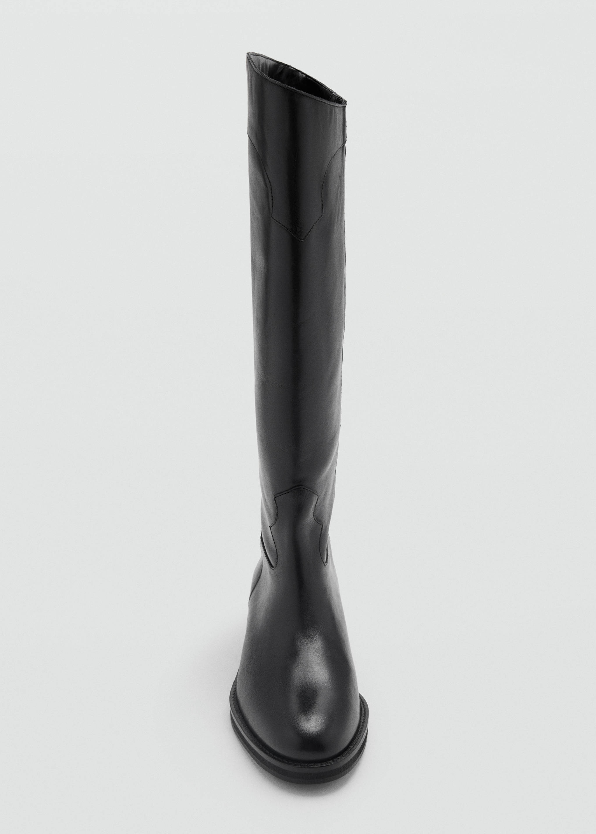 Close-up of a black knee-high boot.