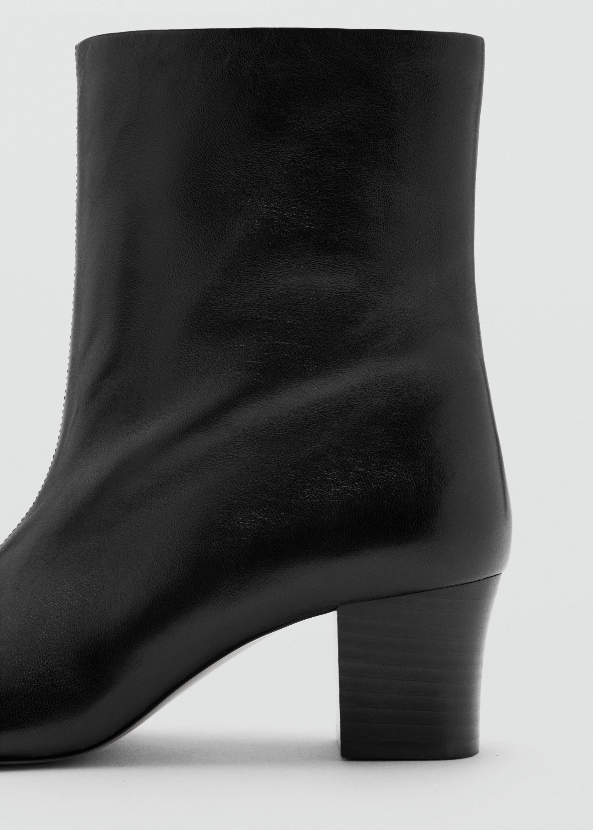 Black leather ankle boot with a block heel.