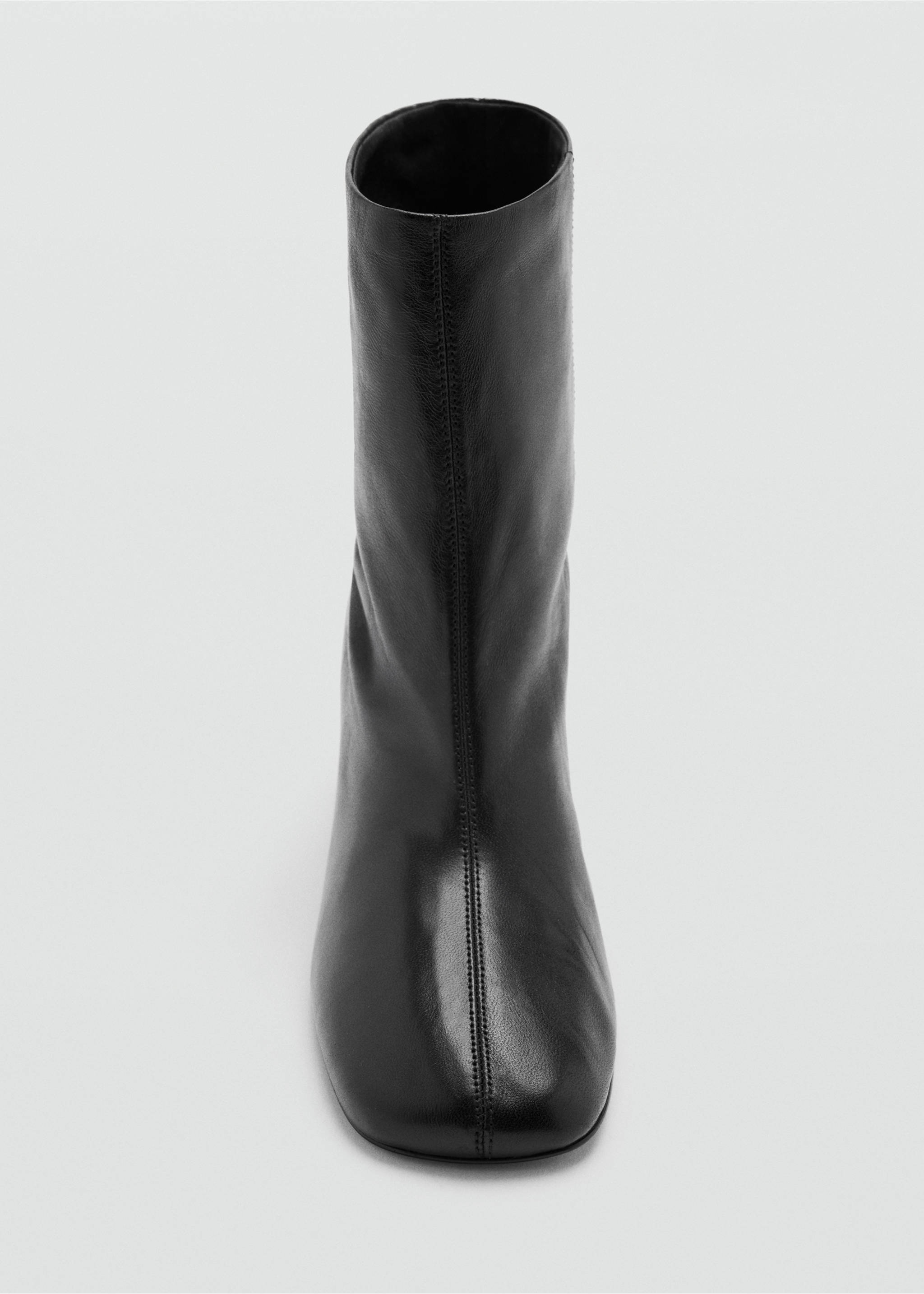 Close-up of a black leather ankle boot with a rounded square toe and central vertical seam., Black. Ref: 47001348-00.