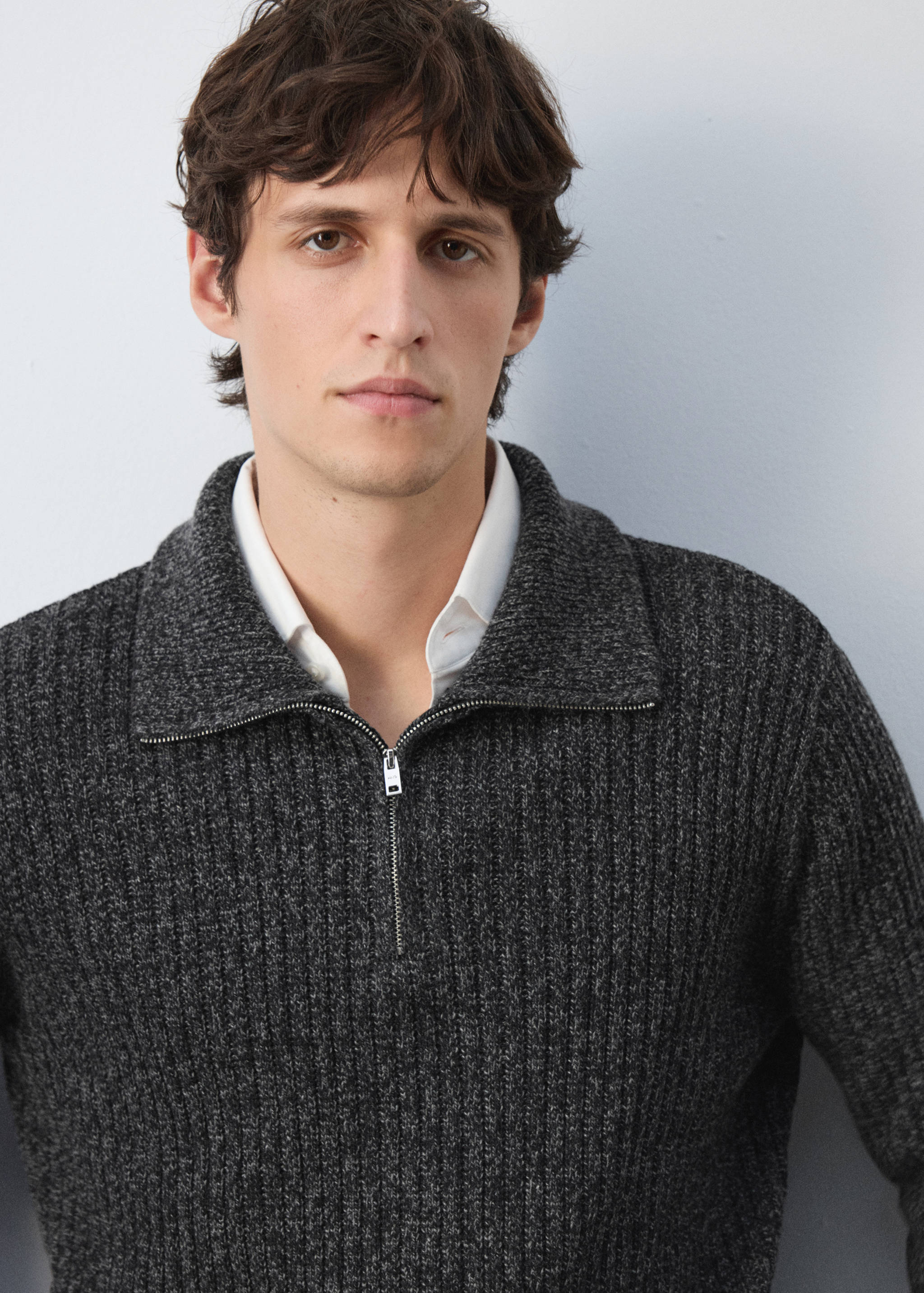 Dark grey ribbed knit jersey with a zip collar.