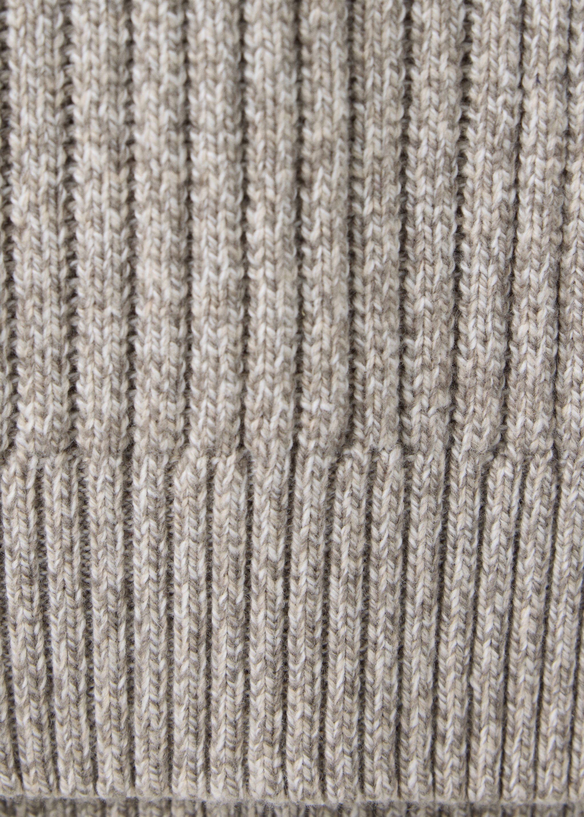 Close-up of a light brown melange jersey showing the ribbed knit texture.