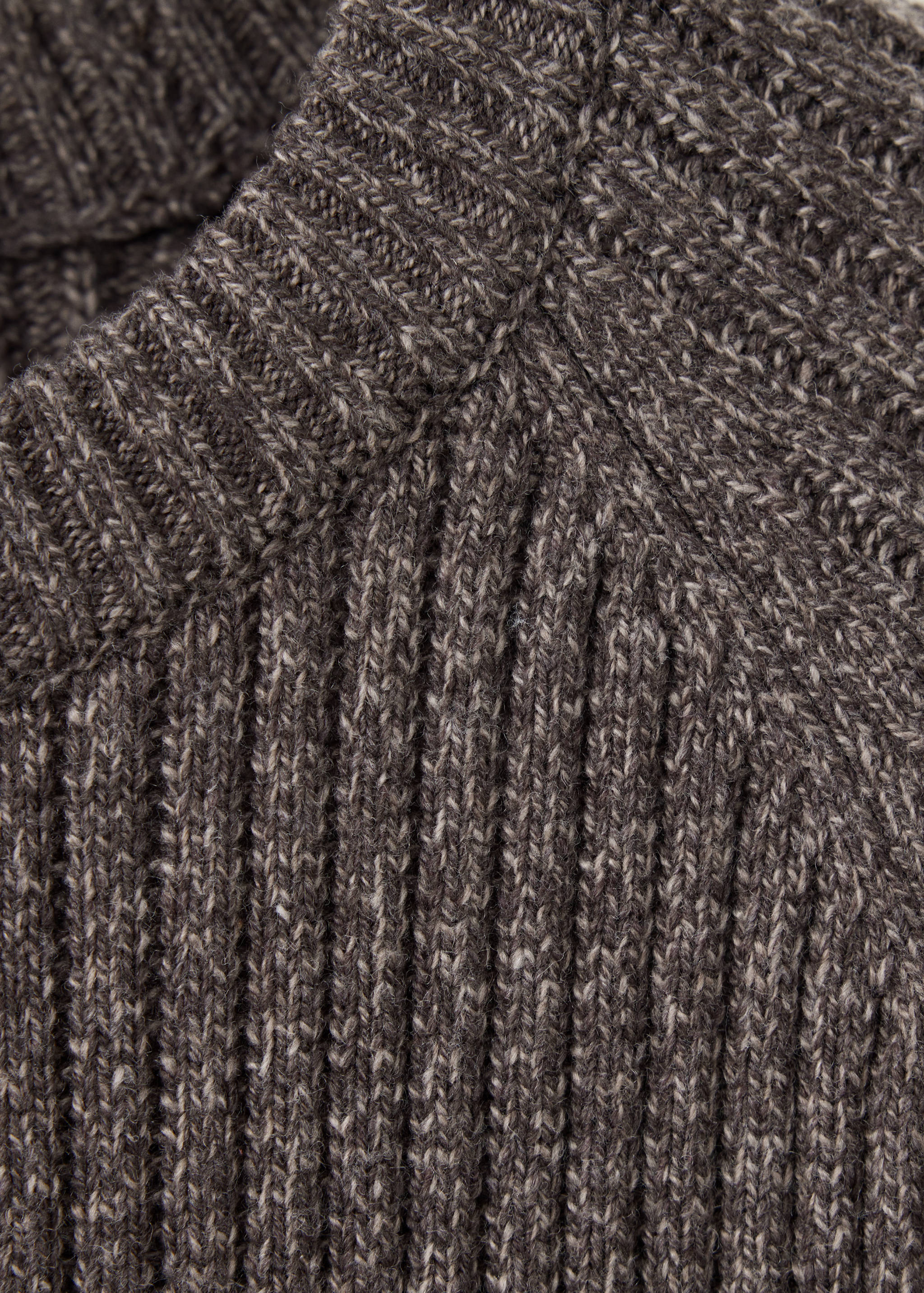 Close-up of a dark brown melange knitted jumper showing the ribbed texture and collar.