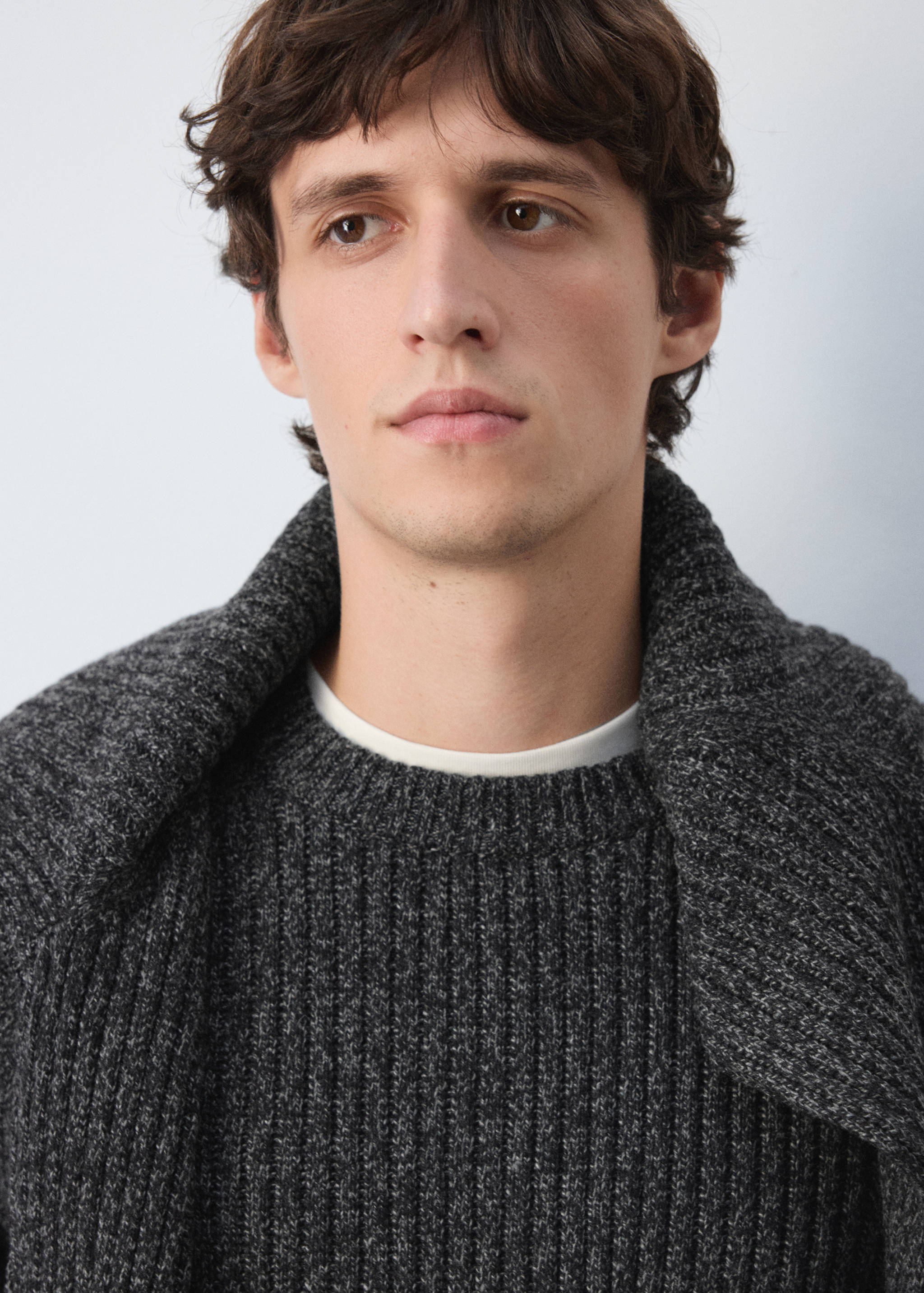 Dark grey ribbed knit jersey with a crew neckline worn with a matching piece draped over the shoulders.