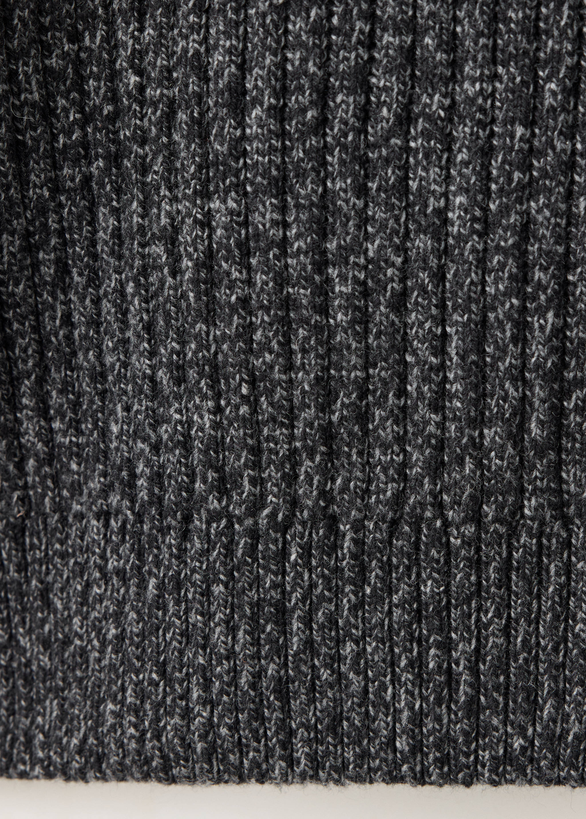 Close-up of the dark grey melange ribbed knit texture of a jersey.