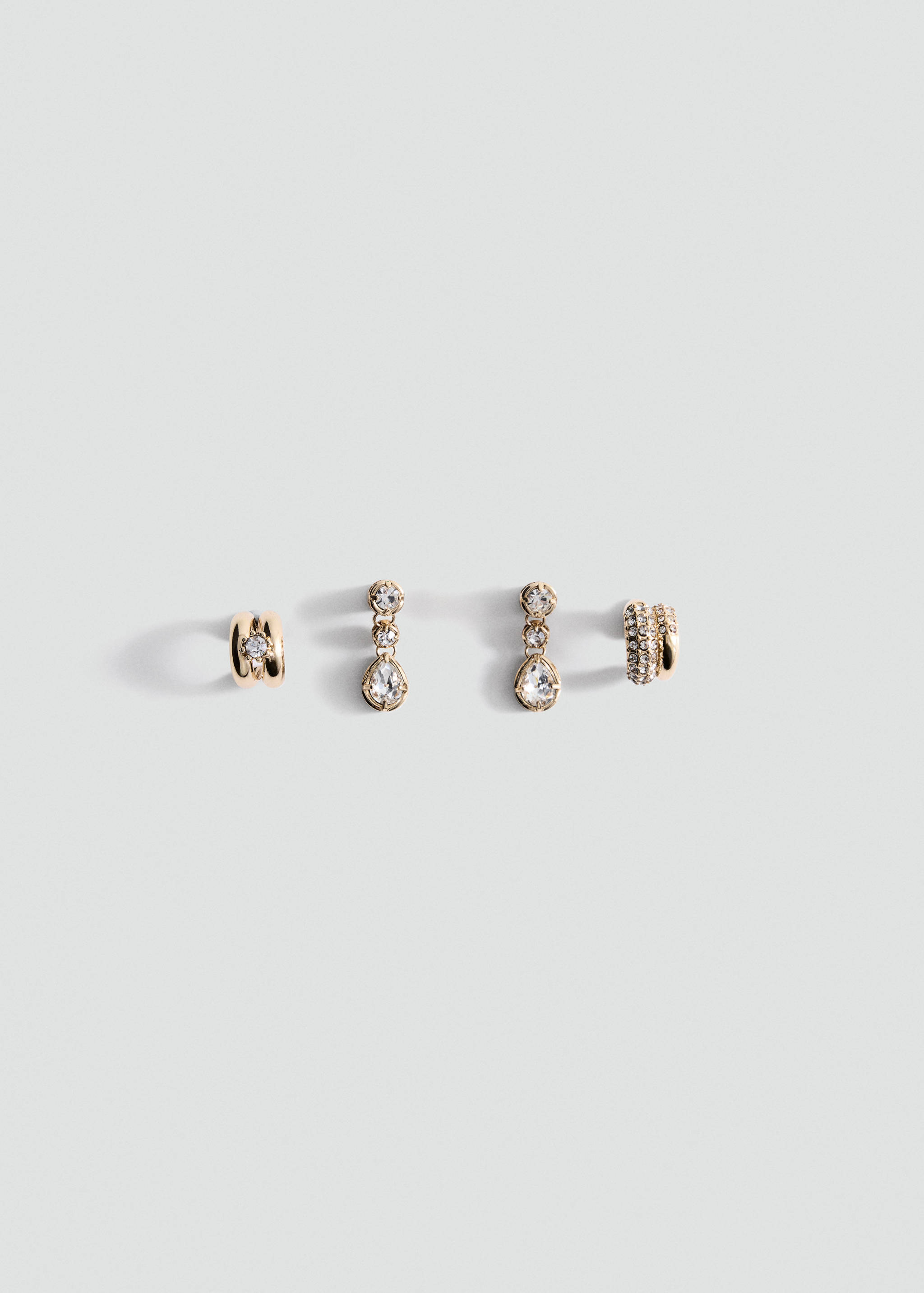 Four-piece gold-tone earring set with pavé hoops and crystal drops.