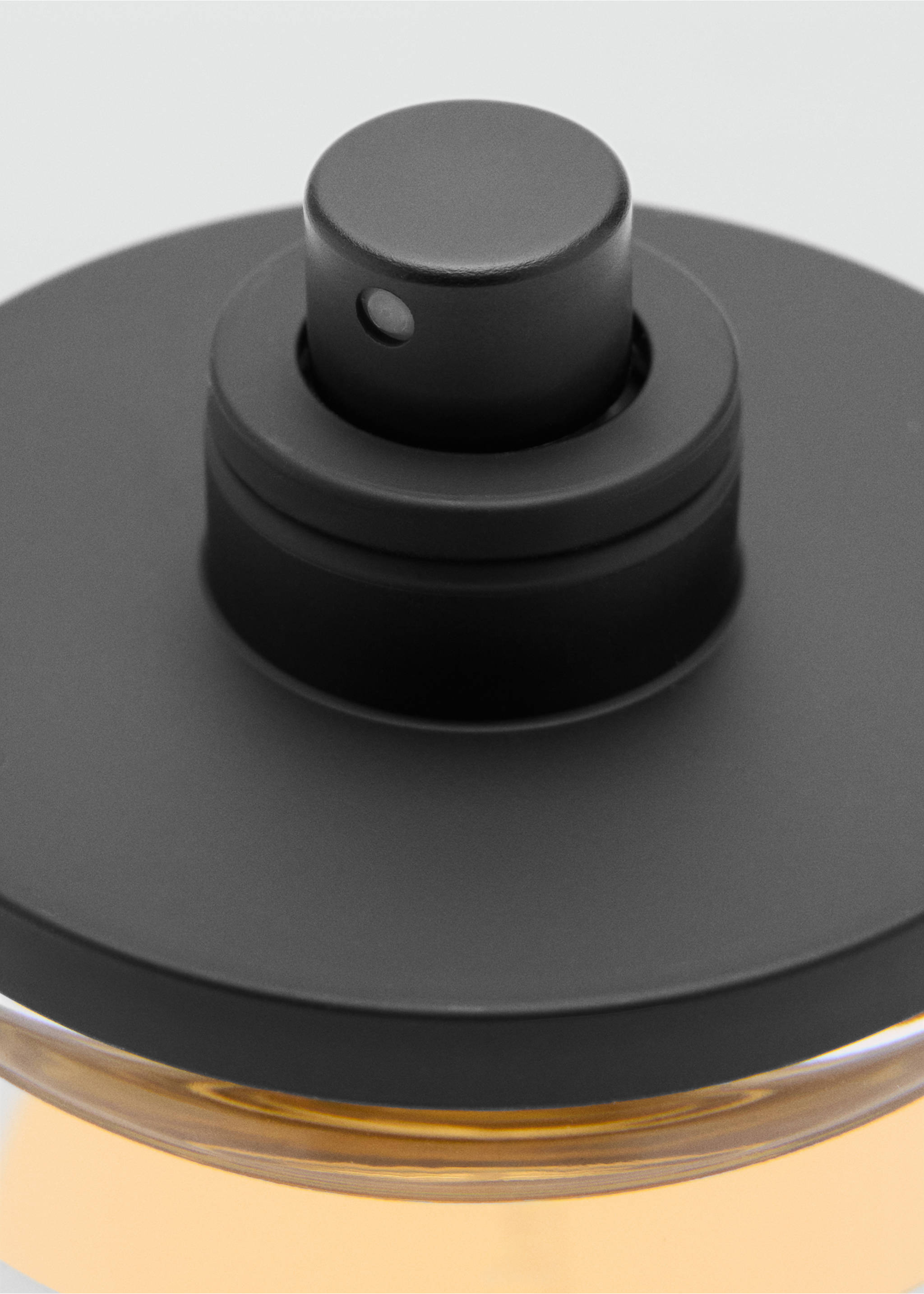 Close-up of a men's perfume bottle with a matte black cap and amber liquid., Mink Grey. Ref: 47001439-00.