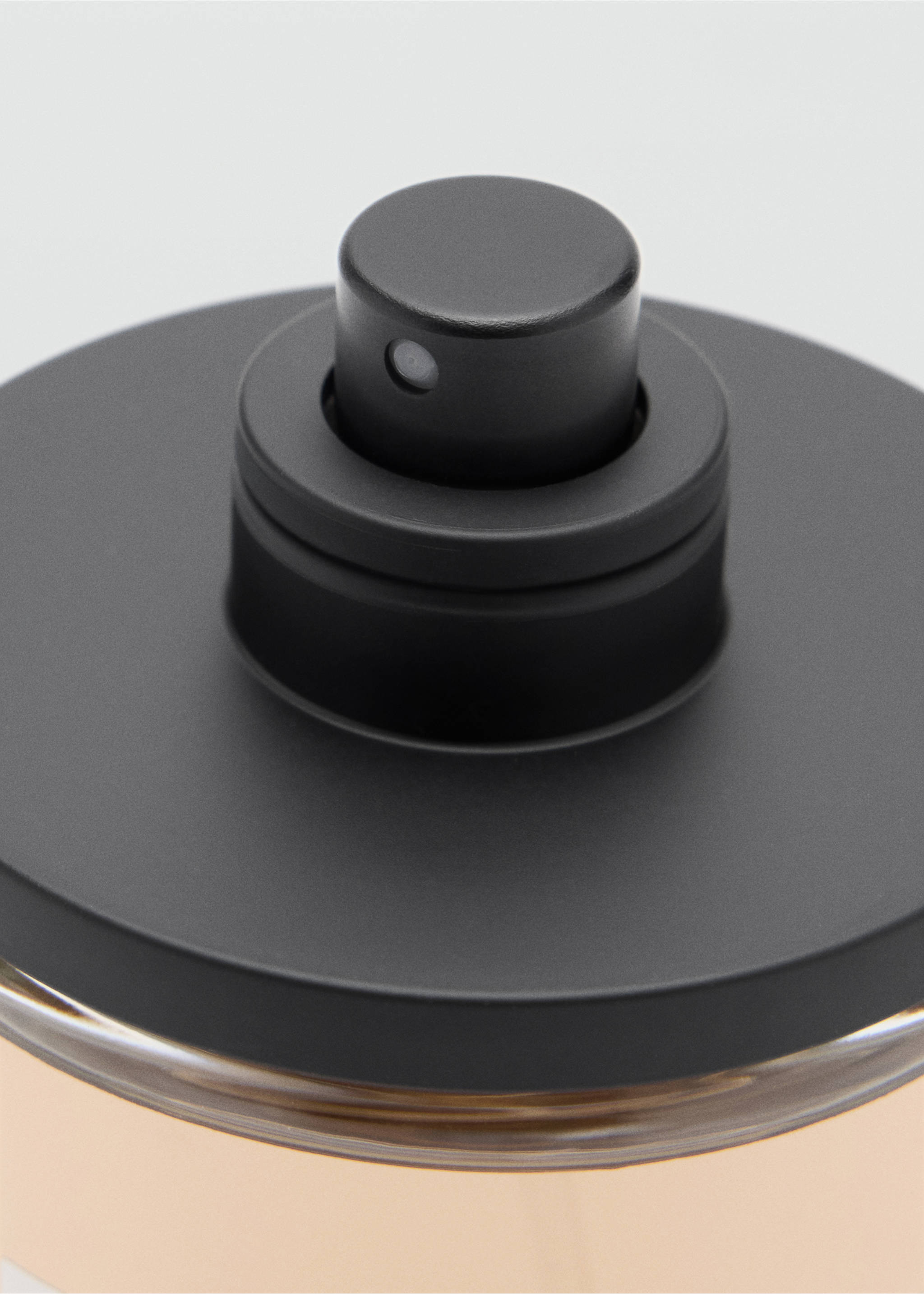 Close-up of a men's perfume bottle with a matte black cap and spray nozzle., Mink Grey. Ref: 47001441-00.
