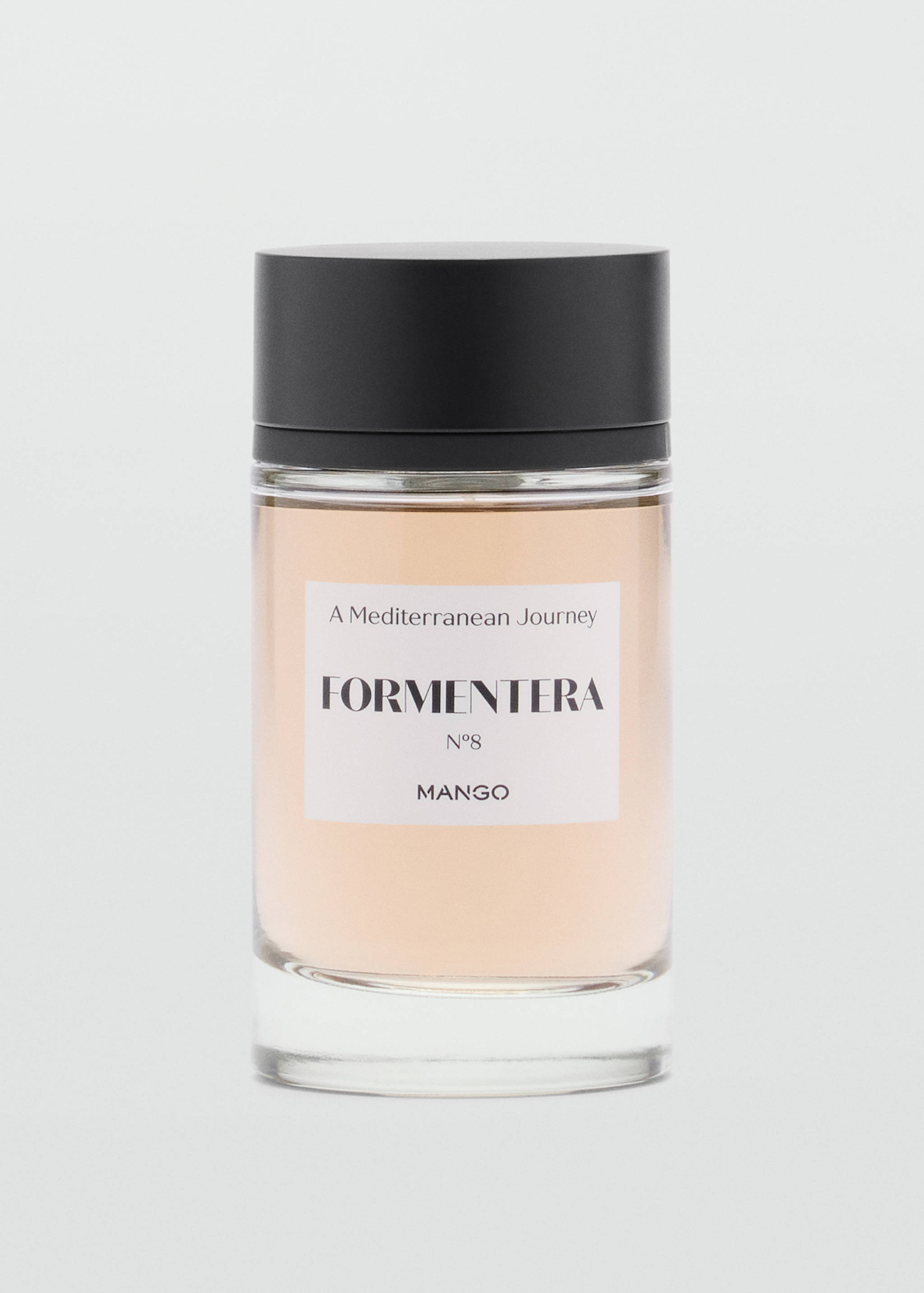 Cylindrical glass perfume bottle with a black cap and a white label.